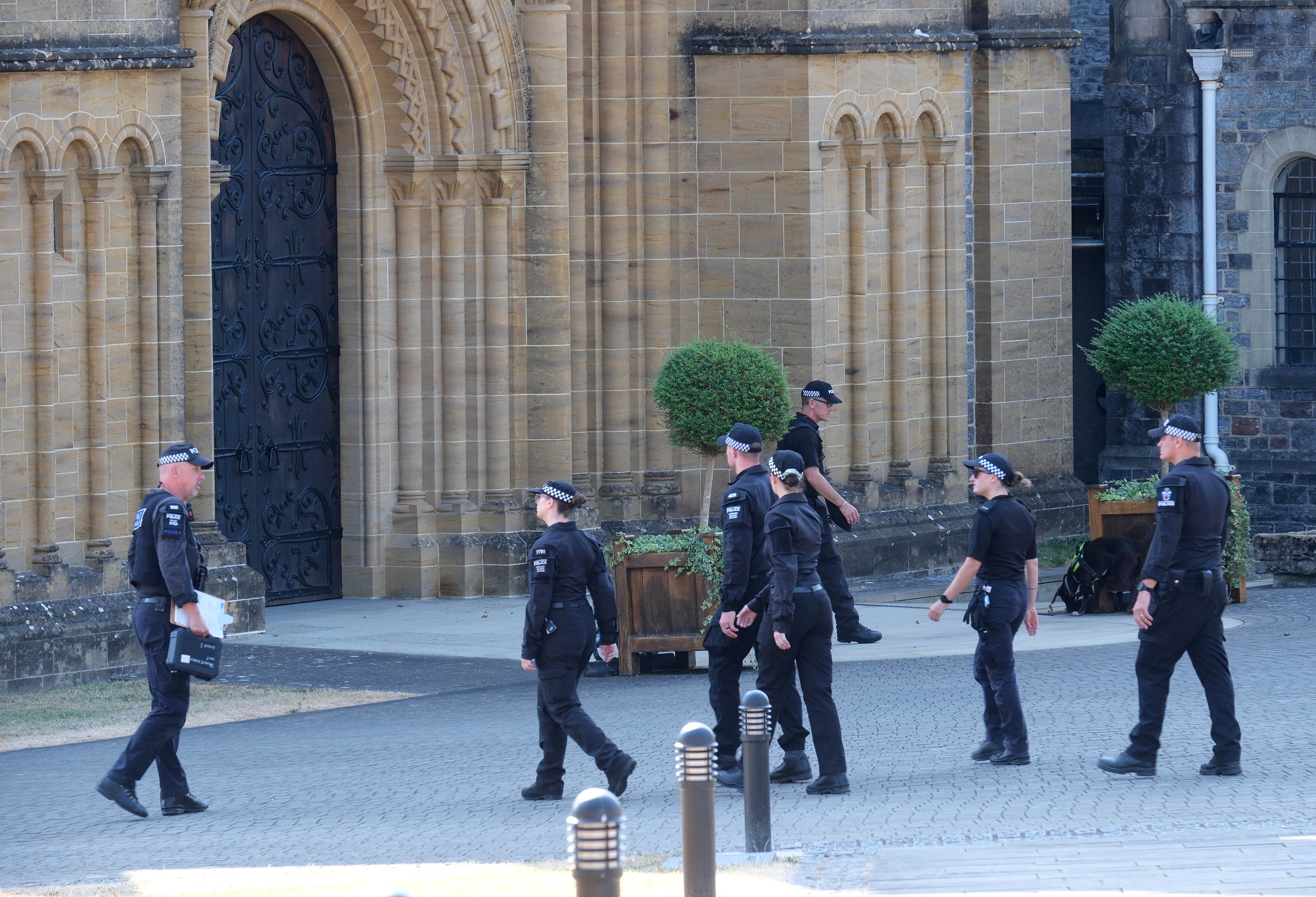 Police officers carry out a security search in the grounds of Buckfast Abbey in Buckfastleigh, Devon, ahead of the funeral of former Tory minister Ann Widdecombe (PA)