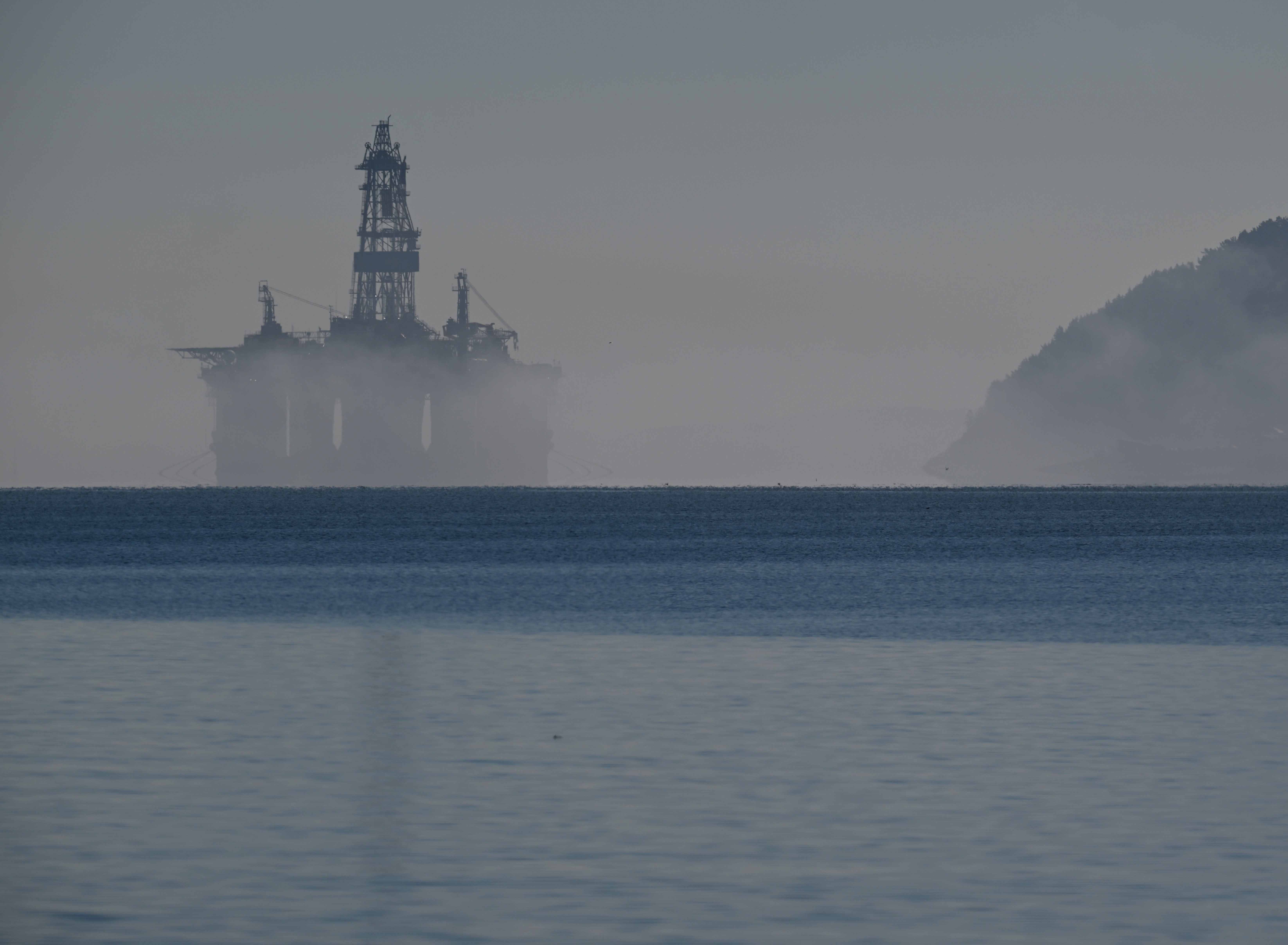 An oil rig is seen through the mist on the Cromarty Firth on the north-east coast of Scotland
