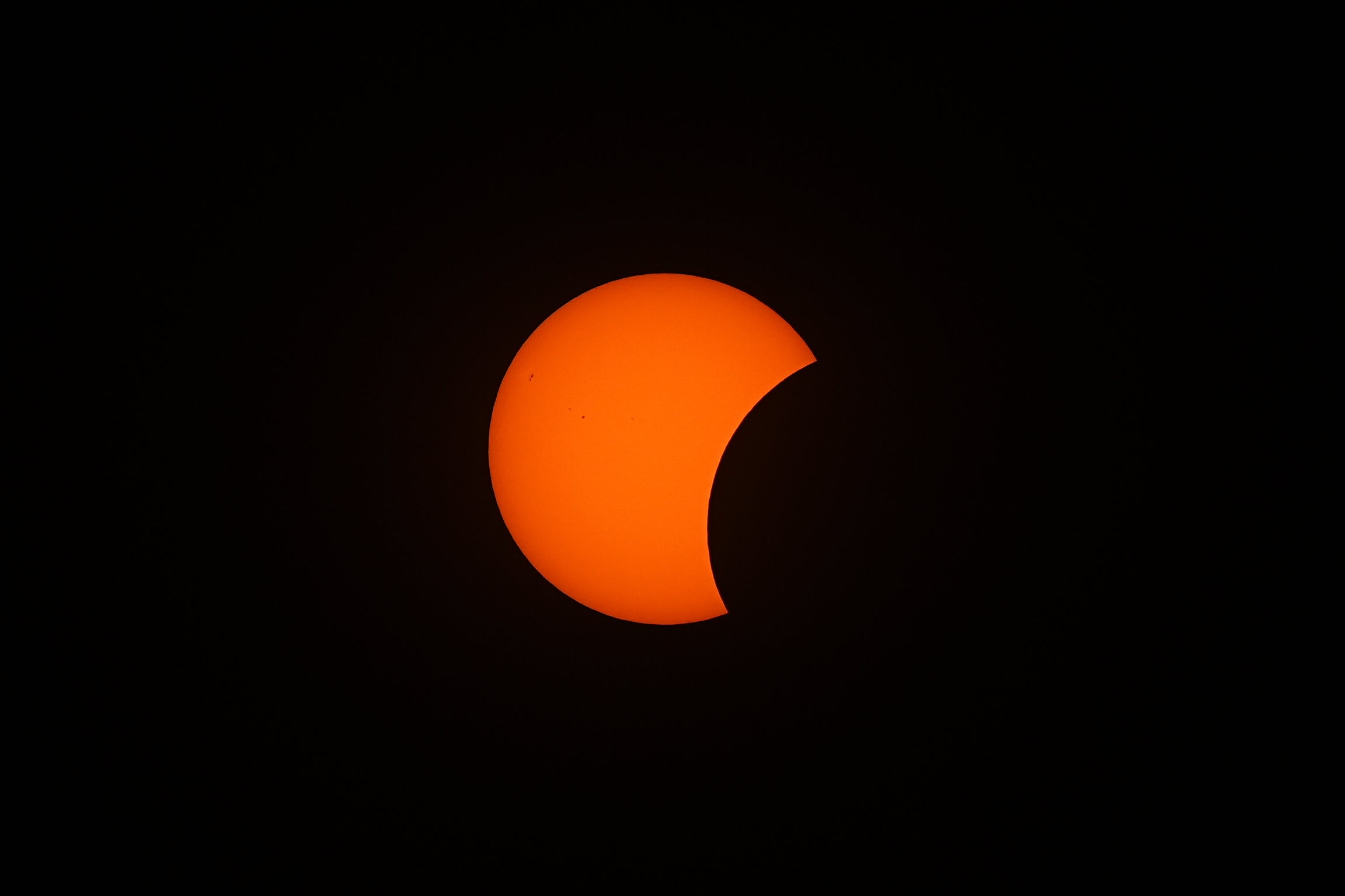 The Moon passes between the Earth and the Sun 6.38pm at the start of the solar eclipse as seen from King's Stairs Gardens in Bermondsey, south London