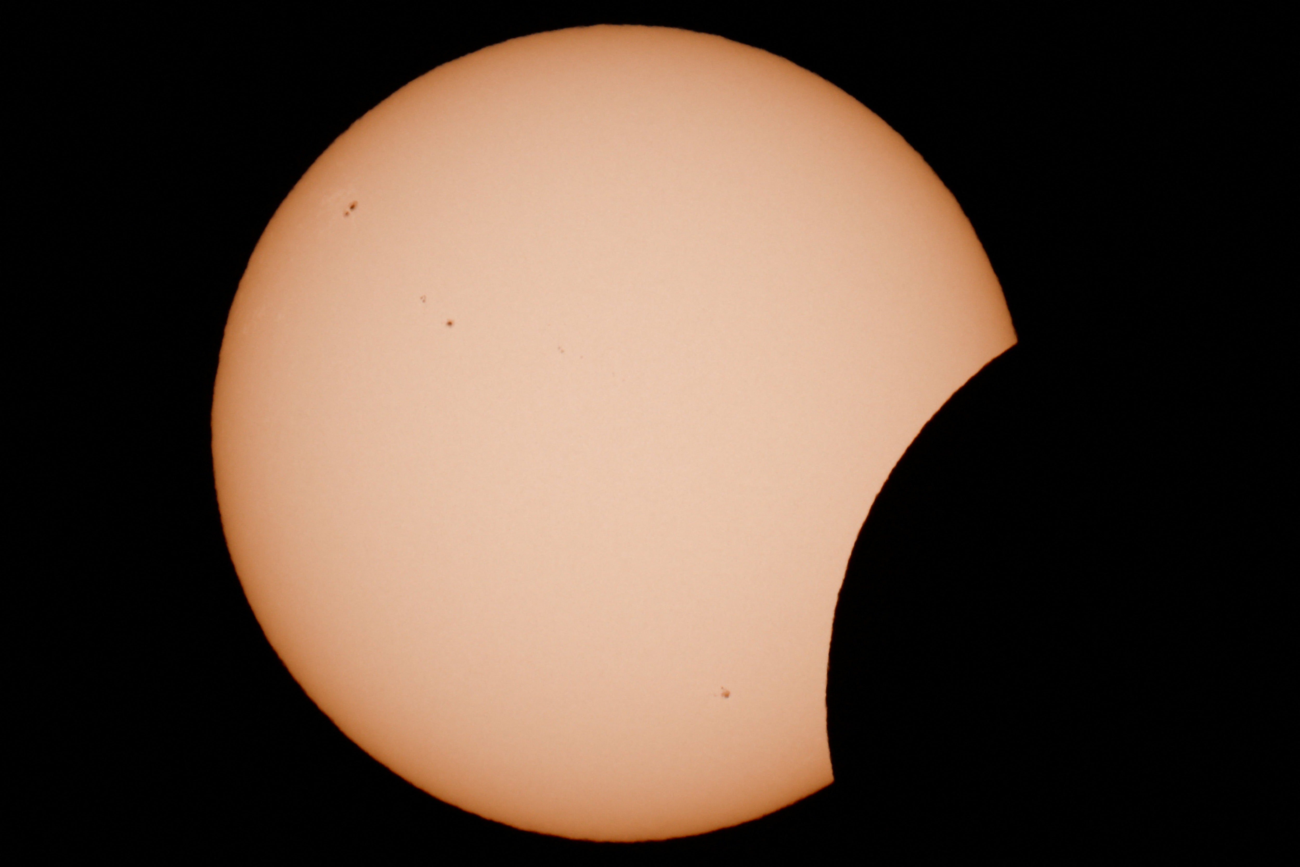 A few of the moon partially covering the sun during a solar eclipse as seen from Arija, Spain