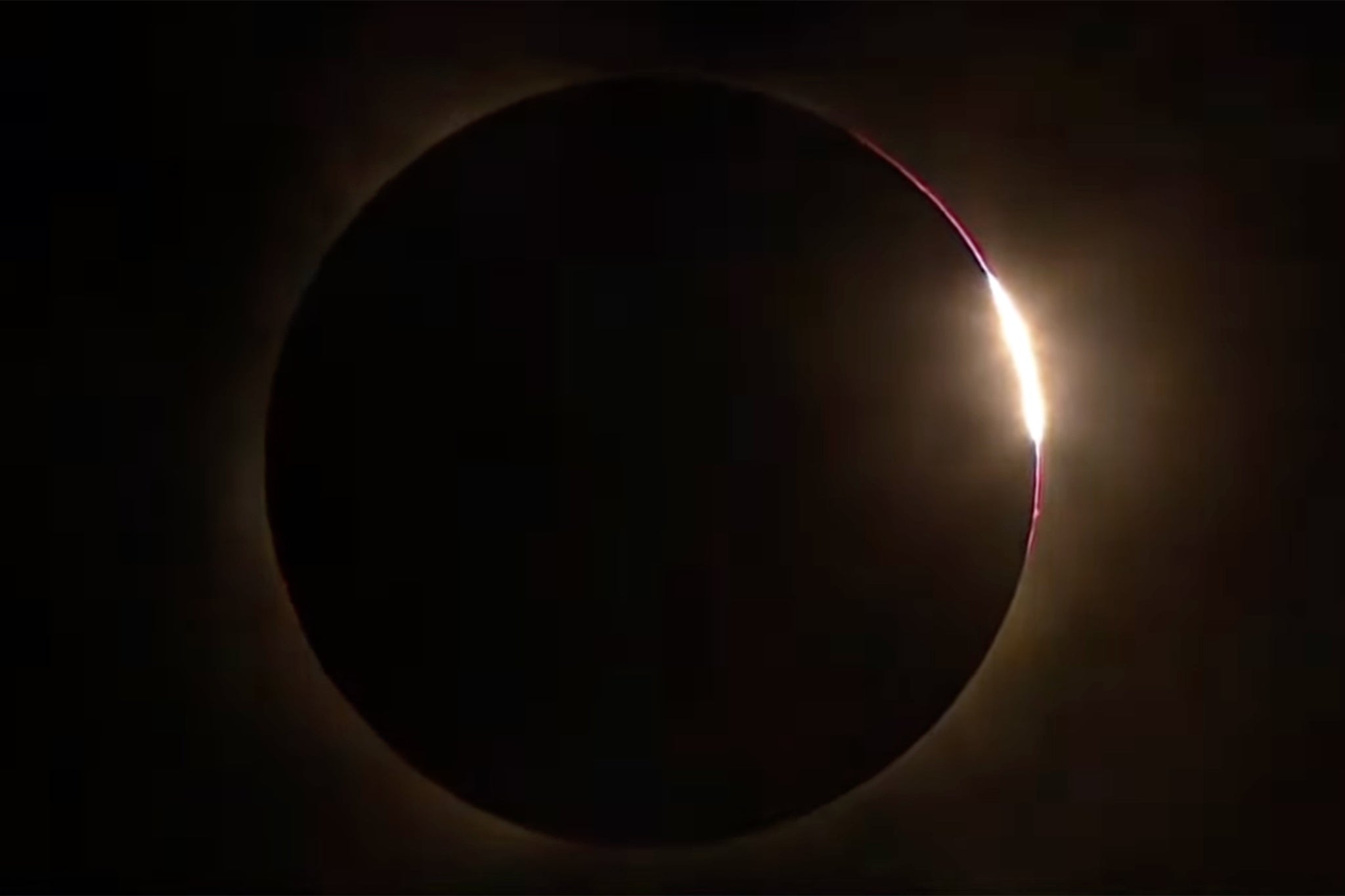 The sun emerging from the side of the moon after the total eclipse in Iceland