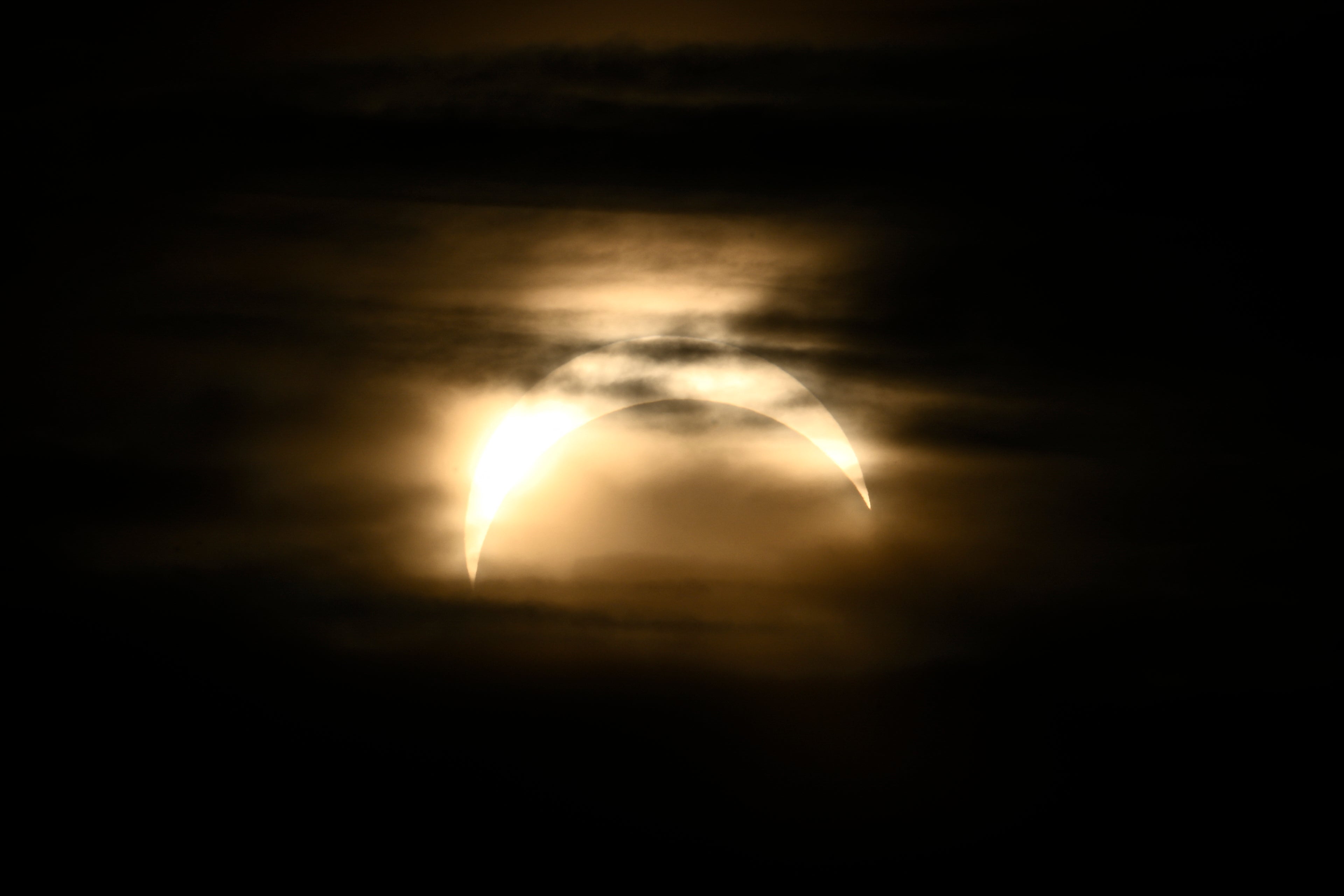 The partial eclipse seen from Observatorielunden park in central Stockholm, Sweden