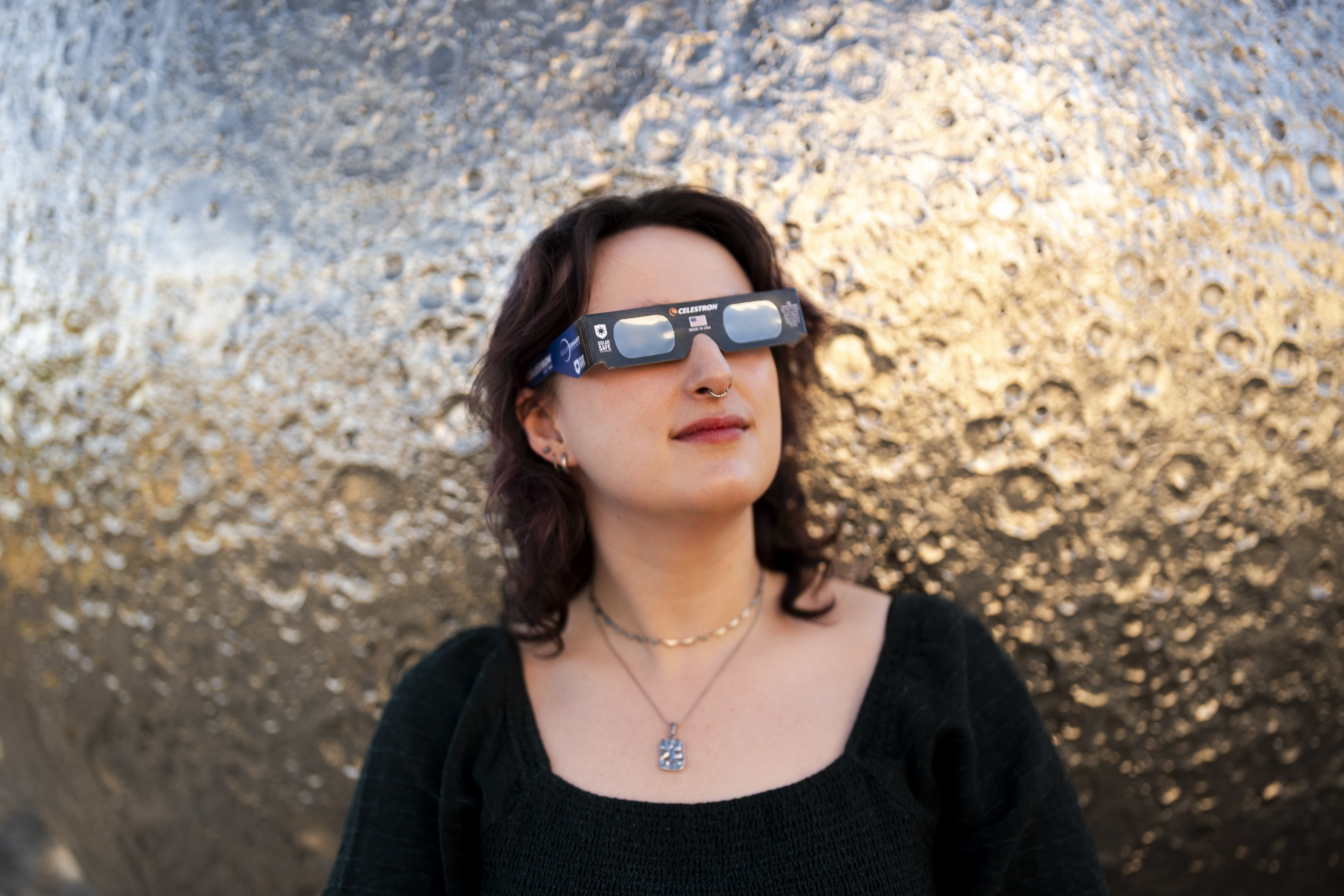 Planetarium Astronomer Dr Carys Herbert demonstrates wearing Celestron solar eclipse glasses (Jordan Pettitt/PA)