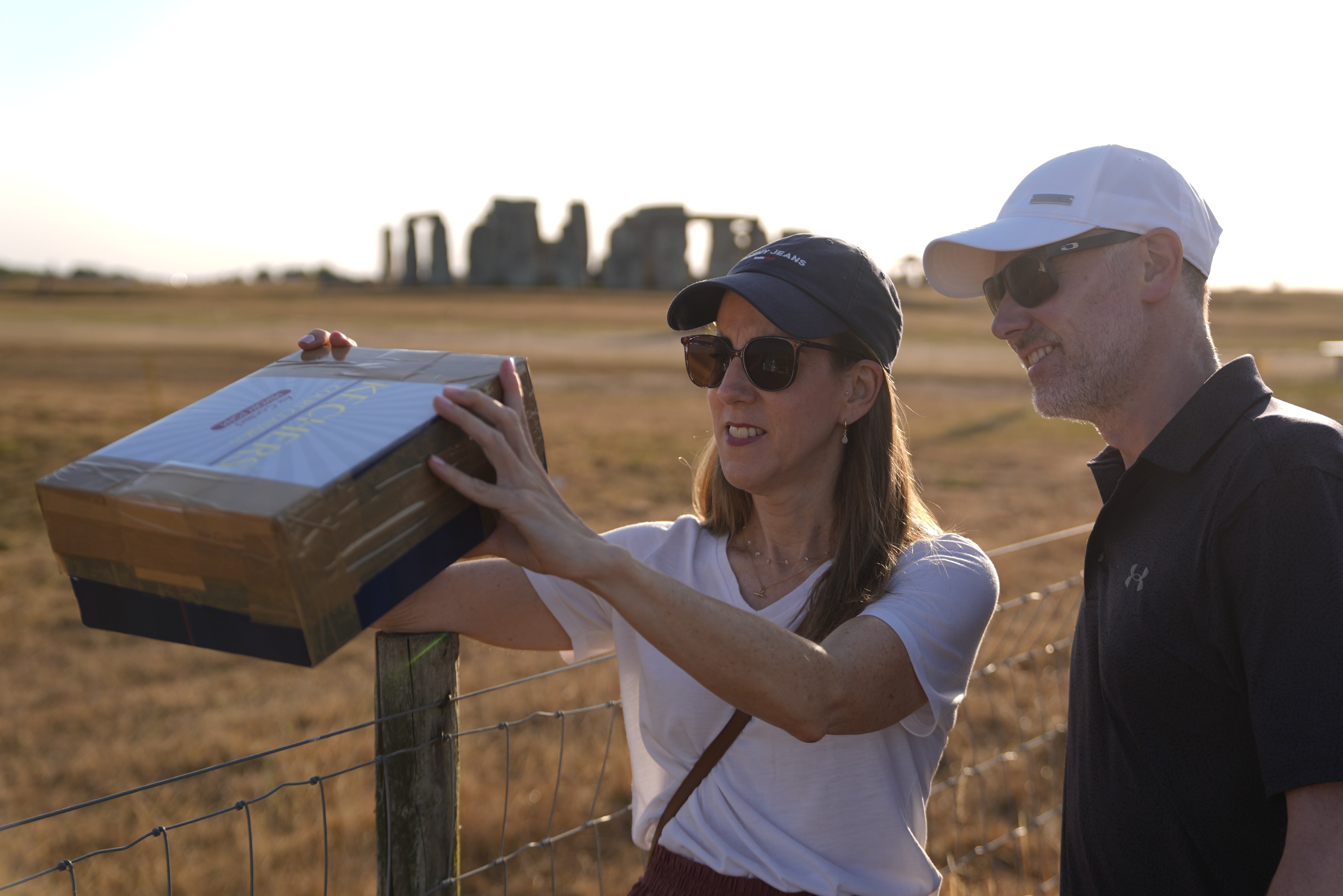 People with a home made device to watch the solar eclipse at Stonehenge (PA) (PA Wire)