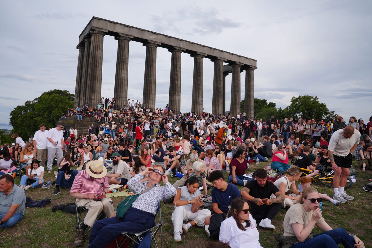 Scots contend with clouds to catch glimpse of rare solar eclipse