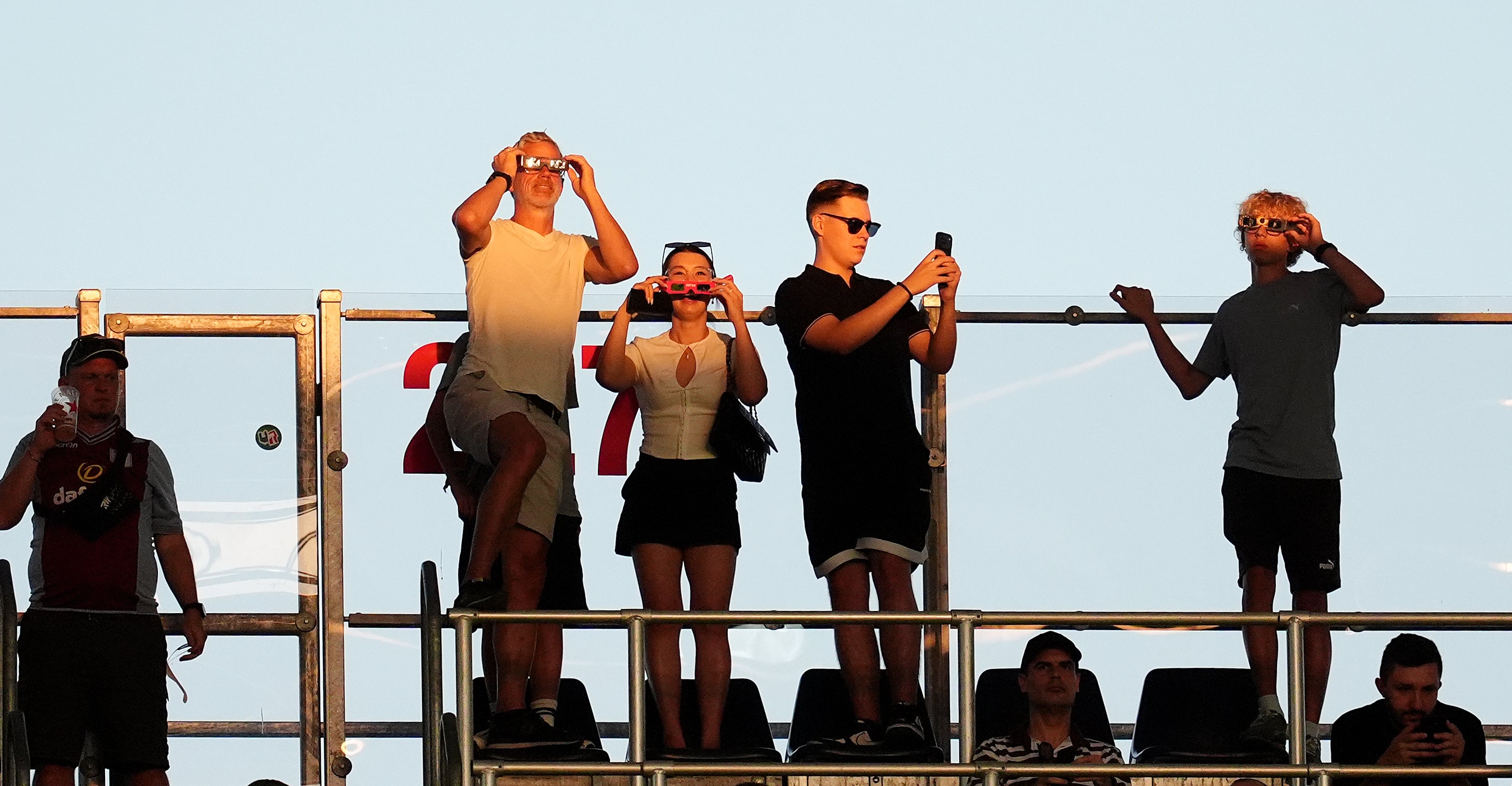 Spectators at the UEFA Super Cup final in Salzburg watch the solar eclipse (Adam Davy/PA)