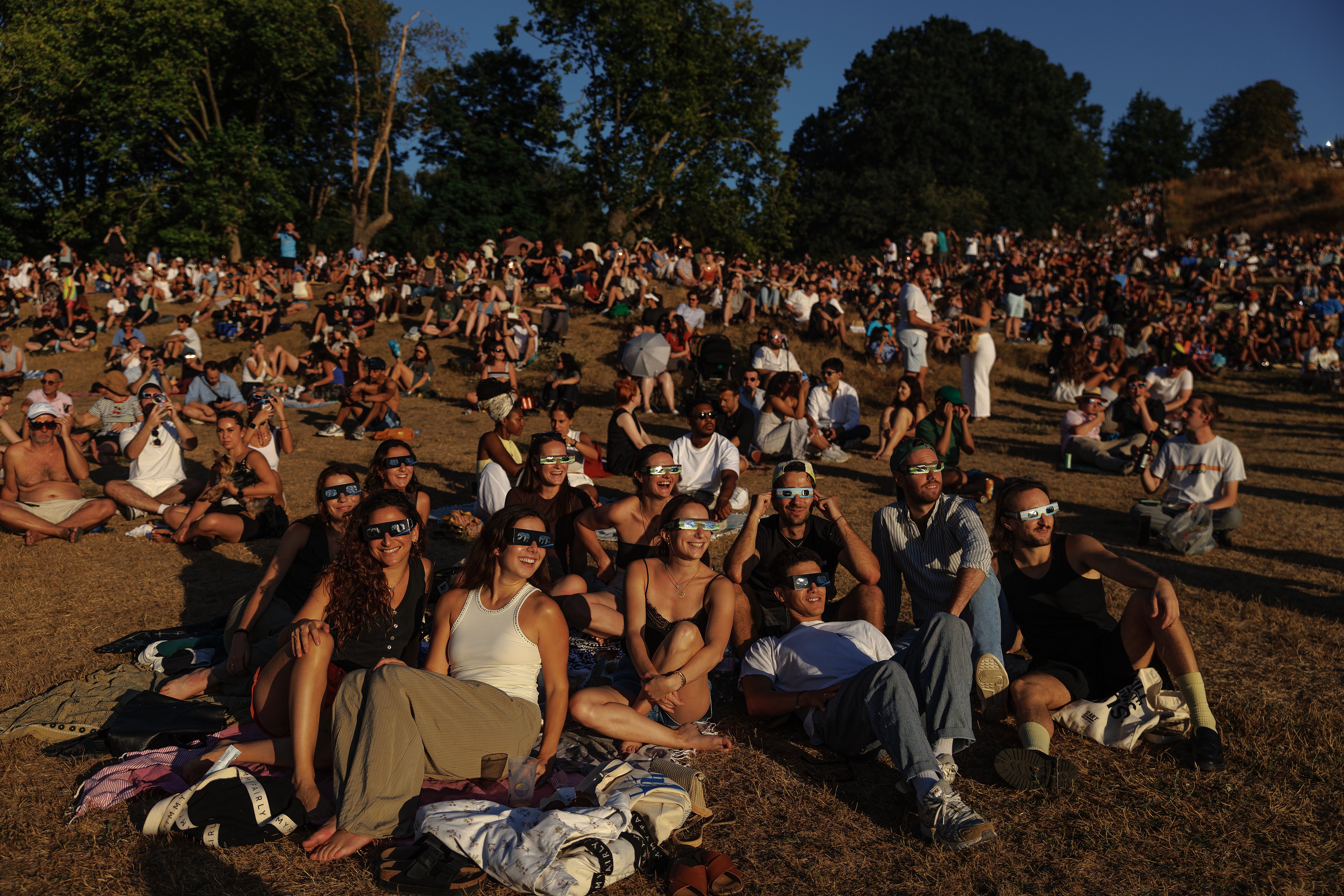 People gather to view the partial solar eclipse in Greenwich Park, in SE London (file) (Getty)