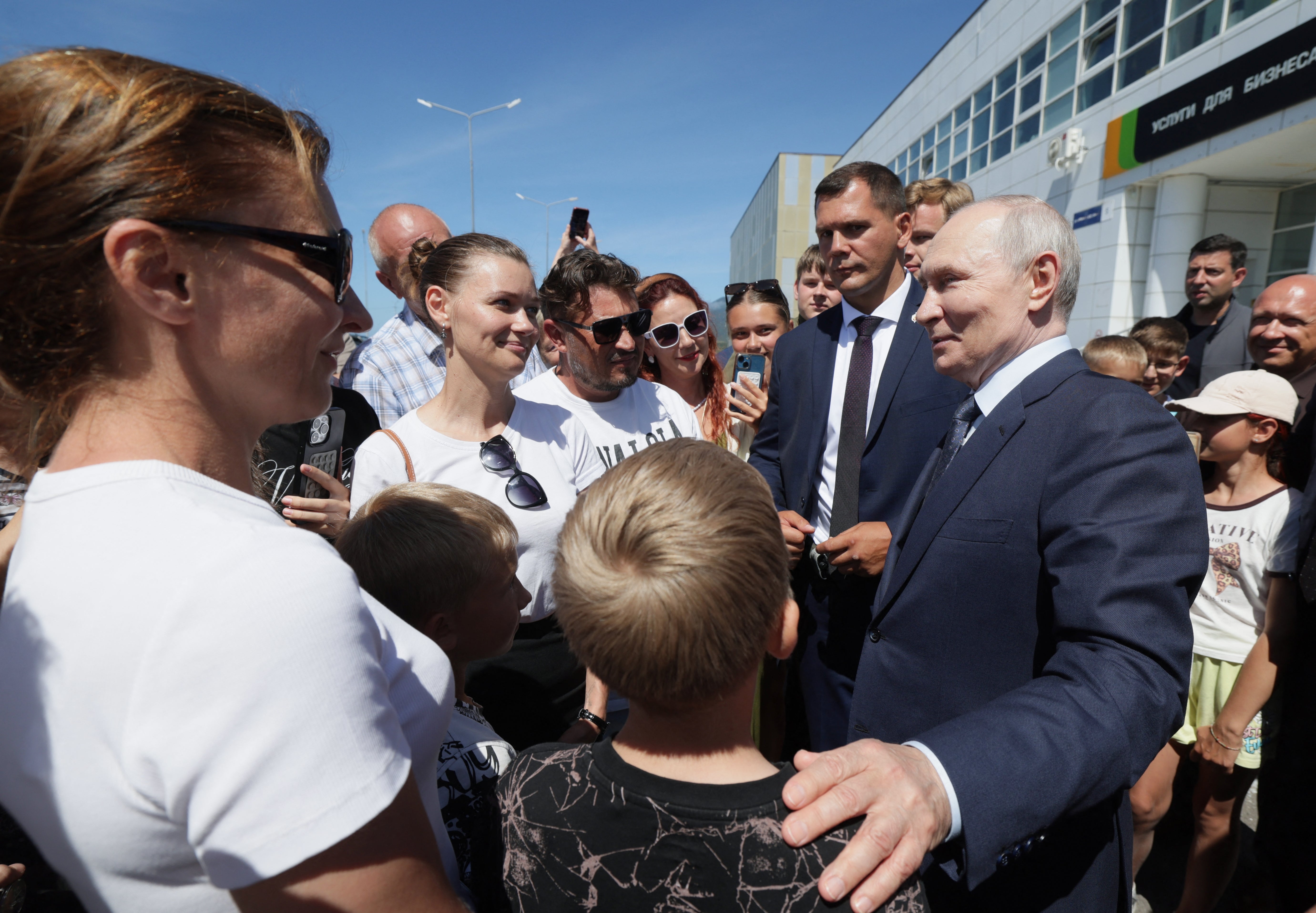 Vladimir Putin interacts with local residents on Iturup island, one of four islands in the contested chain known as the Kuril Islands in Russia and the Northern Territories in Japan