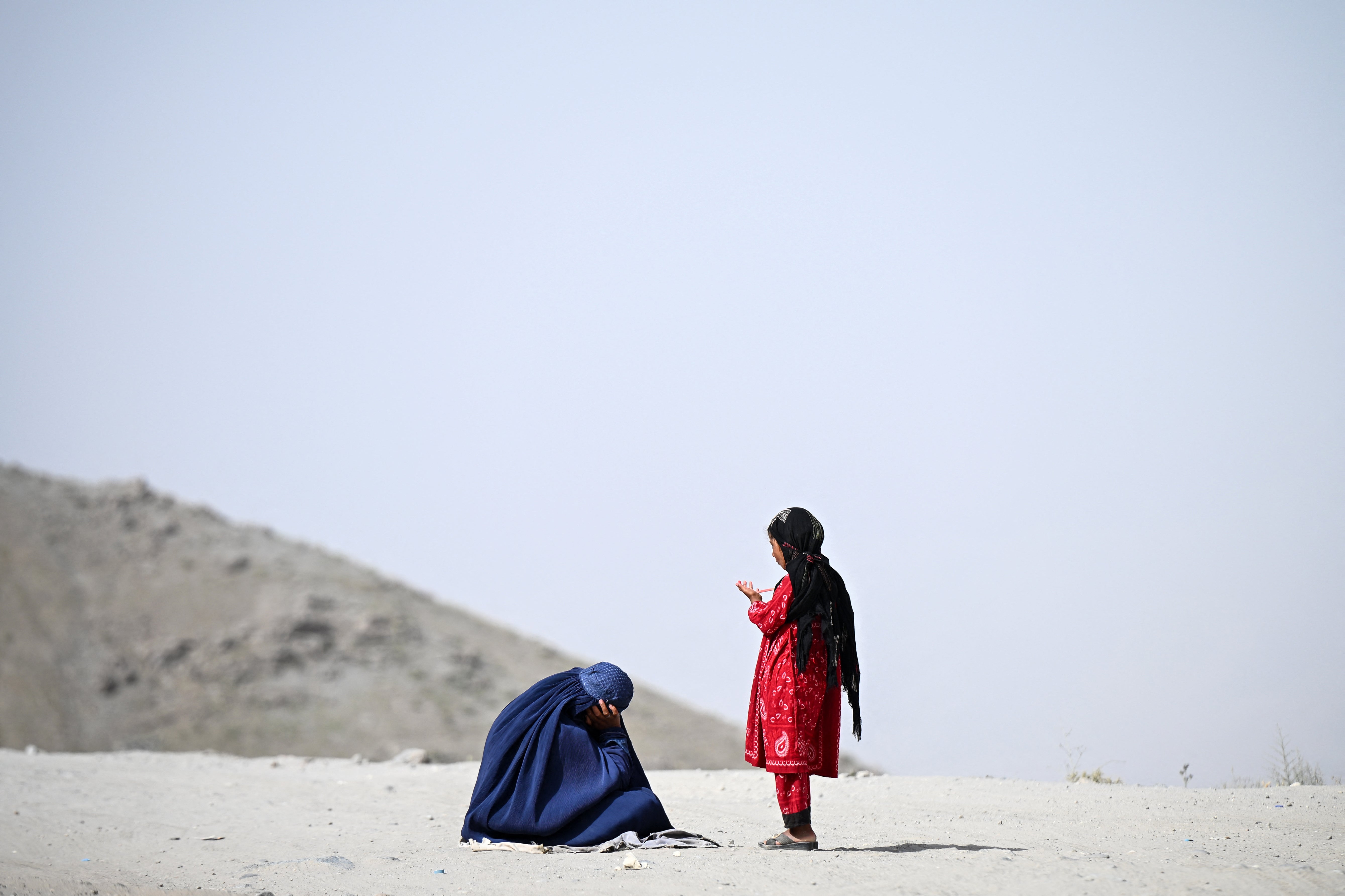 An Afghan woman and a girl seek alms in Argo district of Badakhshan province, Afghanistan