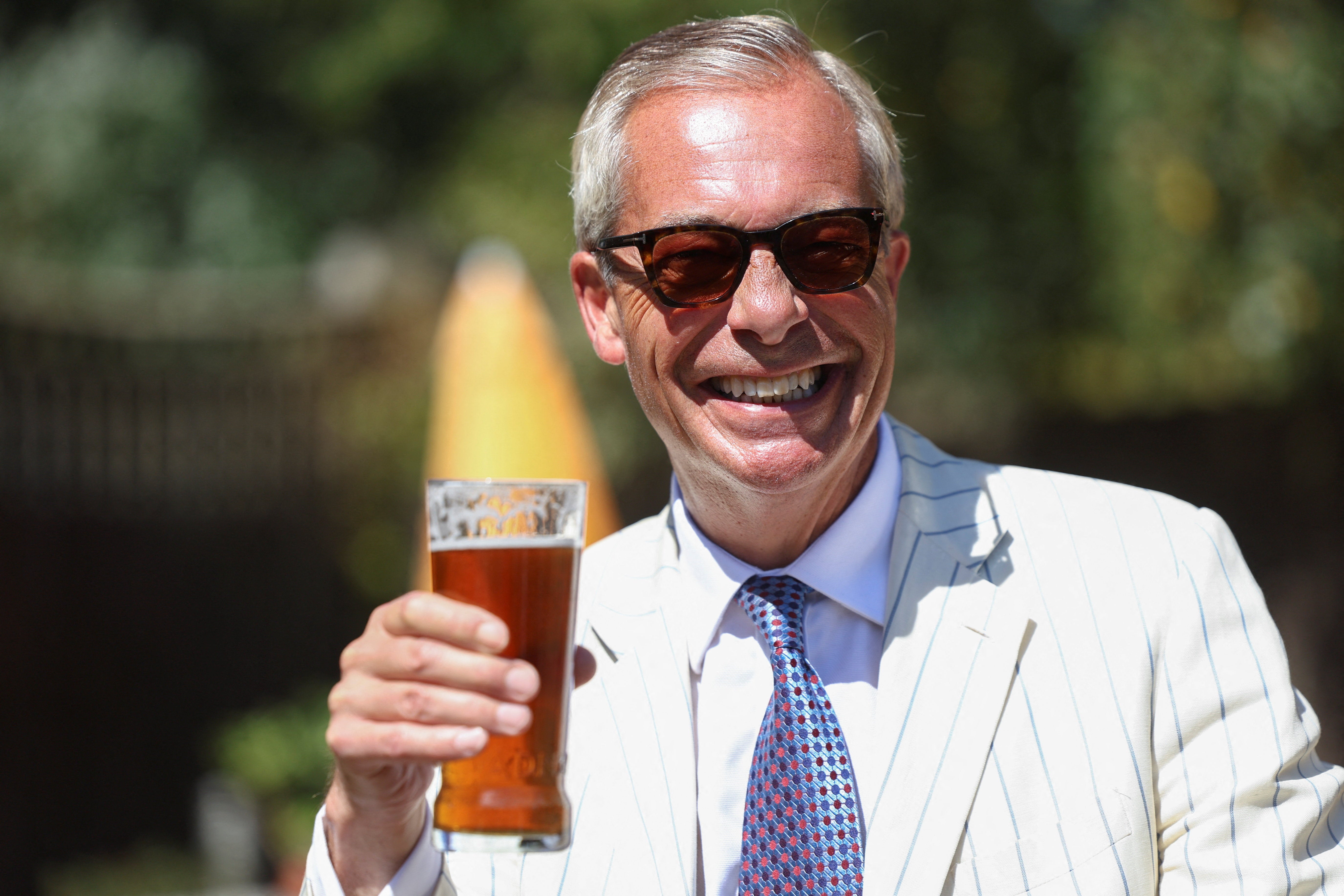 Britain's Reform UK party leader Nigel Farage visits The Ship, on the day of voting in the Clacton by-election, triggered by his own resignation, in Kirby Le Soken, Essex, Britain, 13 August 2026 (Reuters)