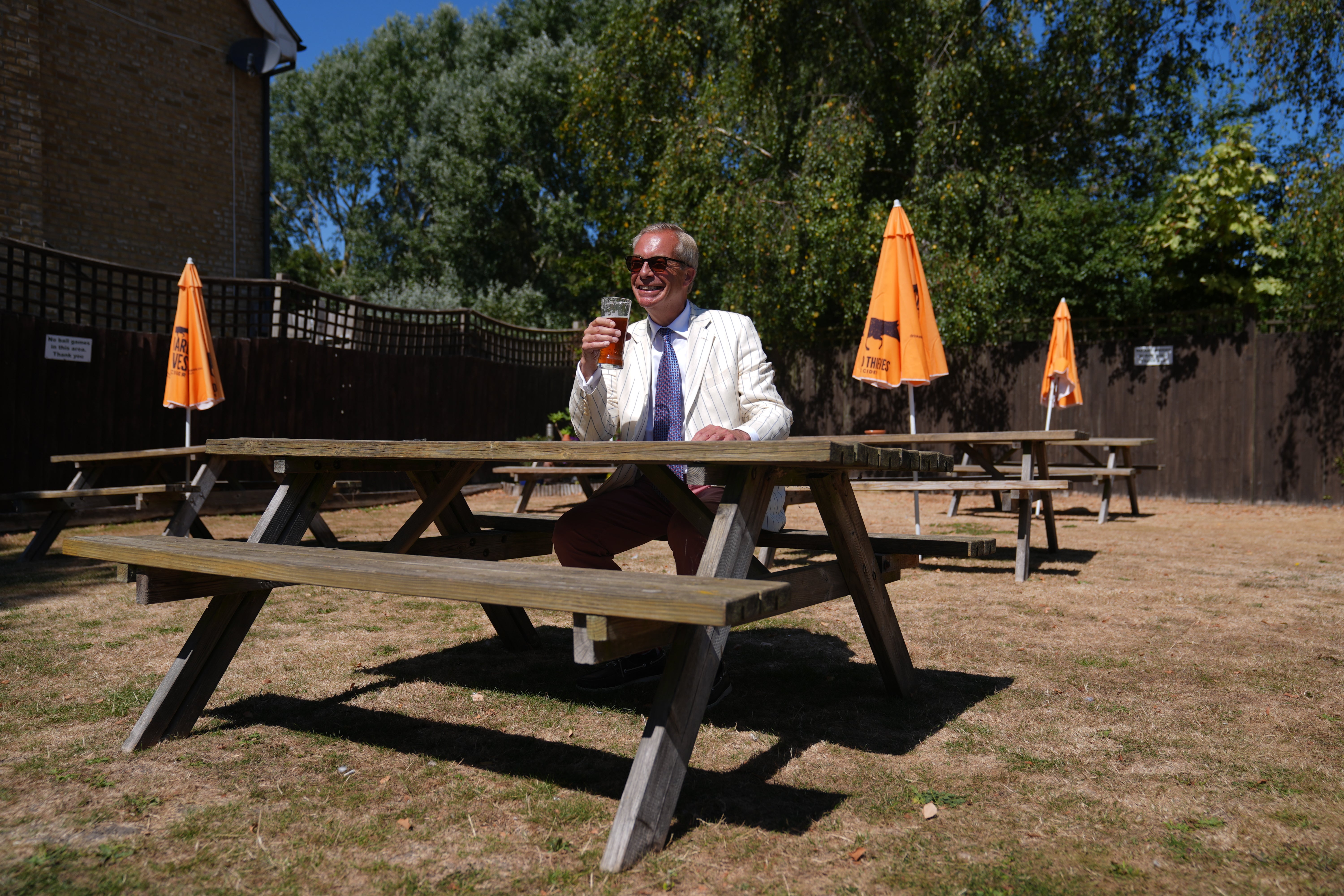 Farage enjoys a pint in the sun on polling day