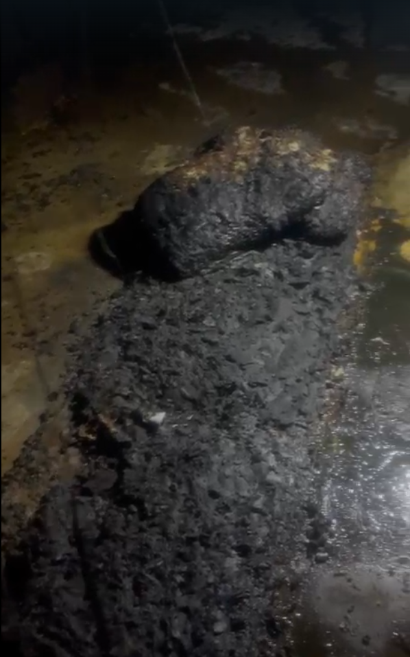 The charred remains of a bed in a home in al-Tuba after settlers burned it down
