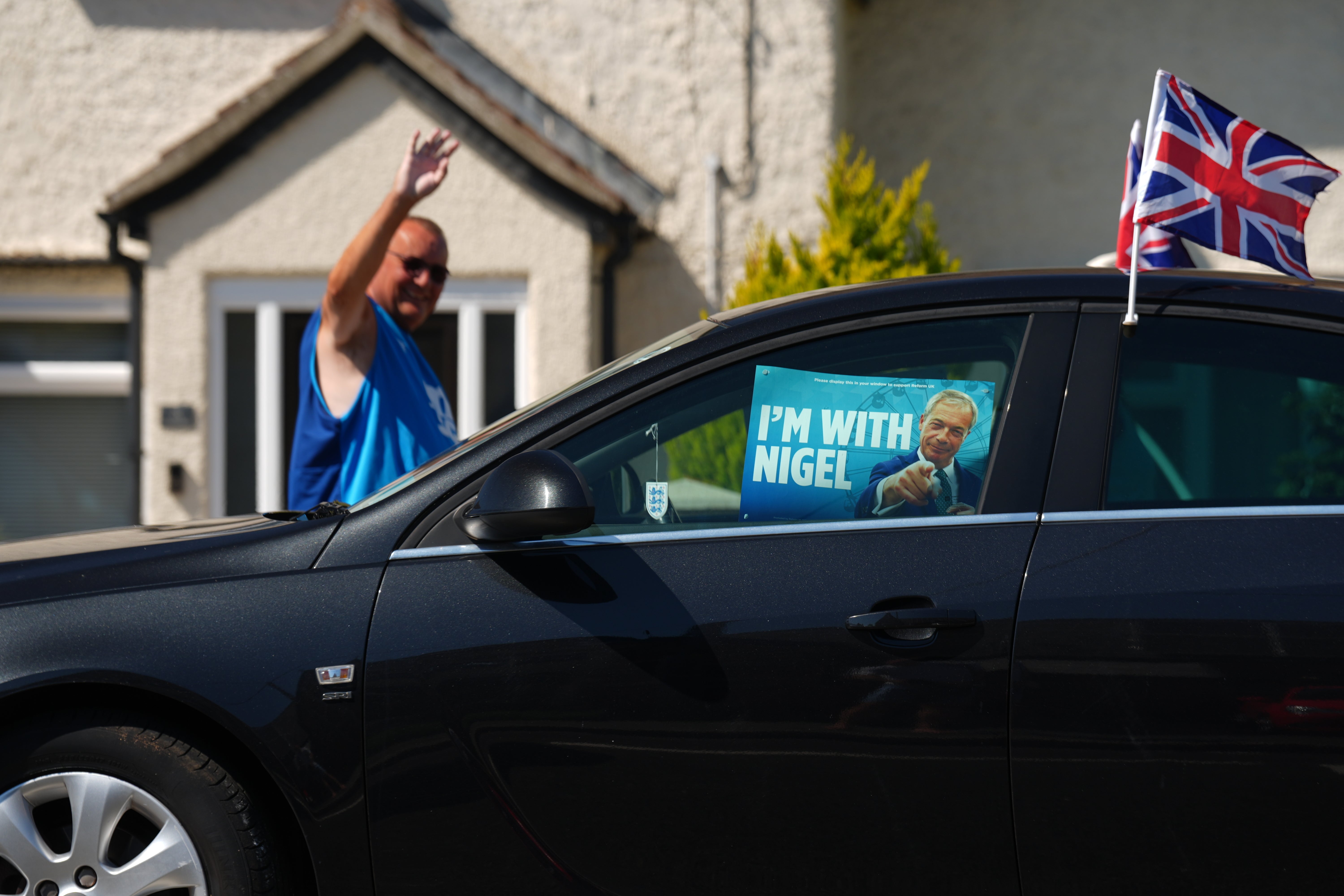A car with a Reform UK leader Nigel Farage poster in Little Clacton (Joe Giddens/PA)
