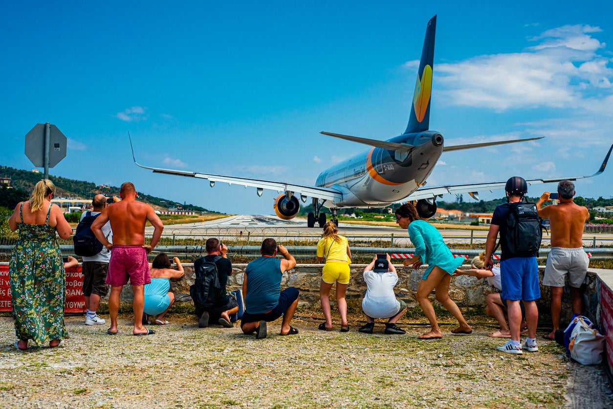 Horror at plane-spotting beach as tourist suffers serious head injury after being blasted by flight