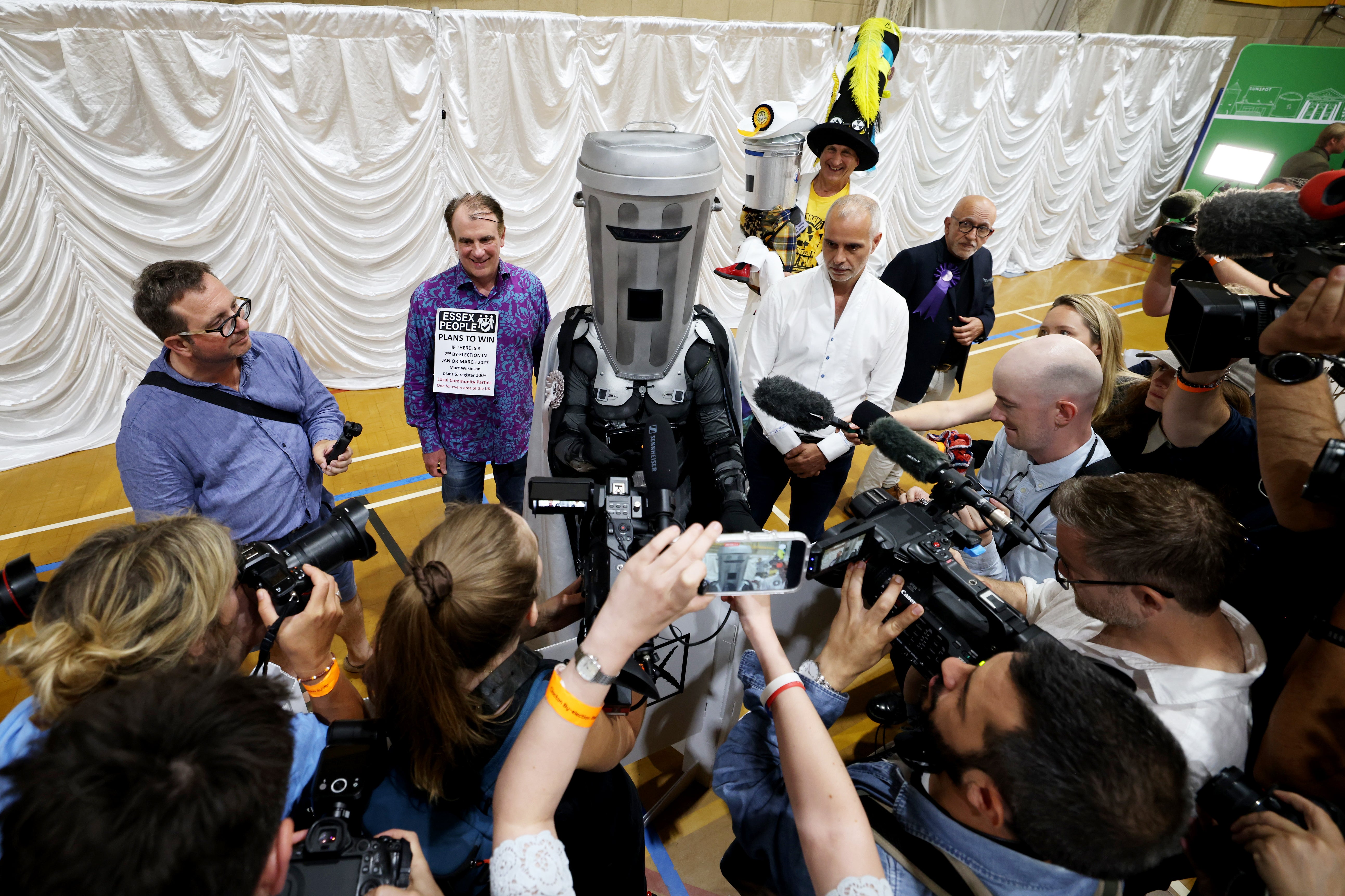 Jon Harvey, dressed as the satirical character Count Binface, speaks with members of the media following the declaration of the Clacton-on-Sea by-election at Clacton Leisure Centre on 14 August 2026 (Getty)
