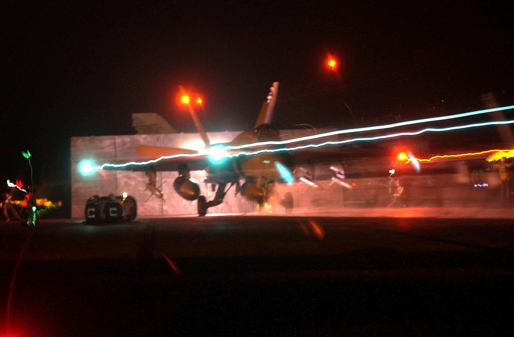 An F/A-18 Hornet launches from one of four steam driven catapults at night on the flight deck of USS Constellation 21 March 2003