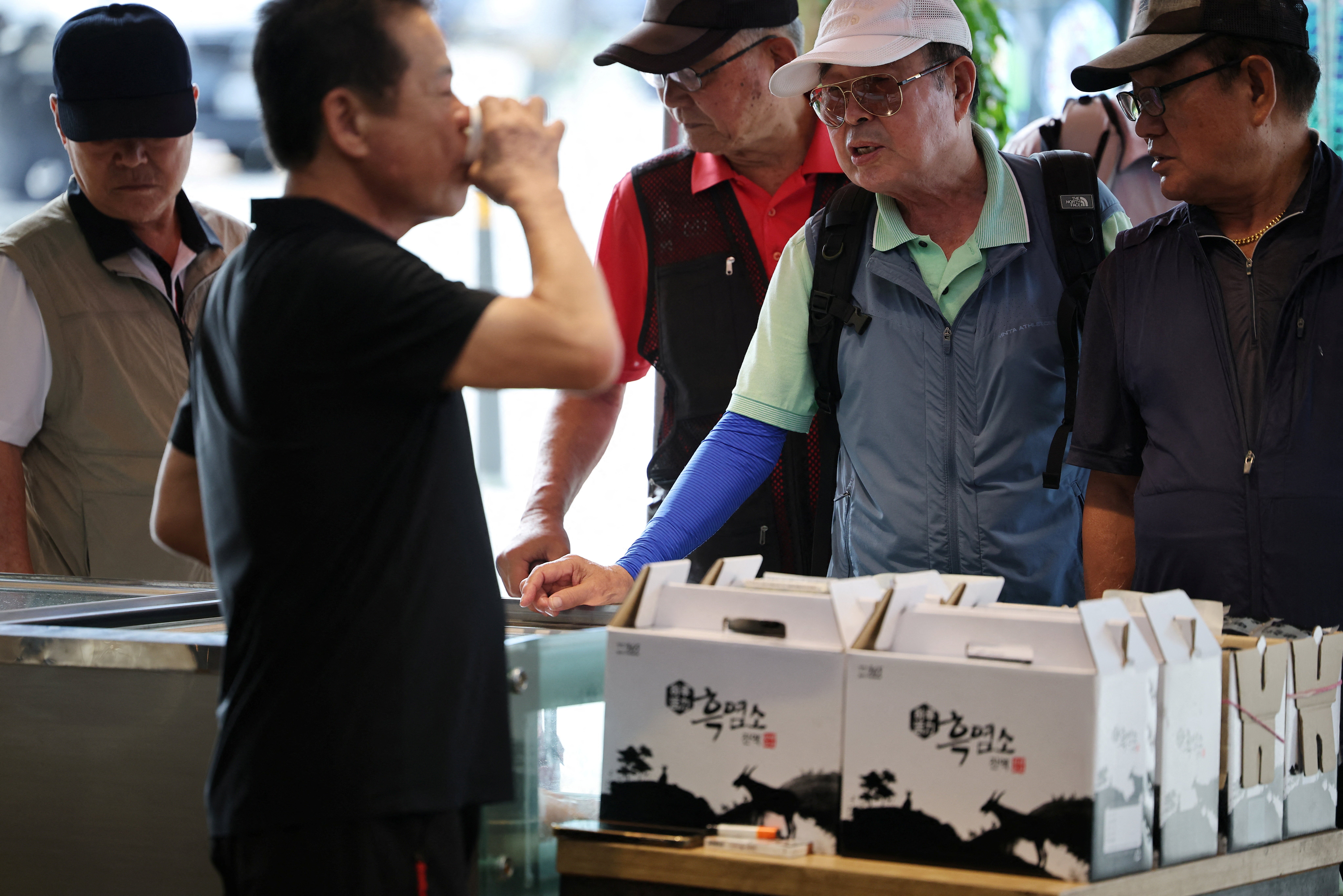 Customers shop for dog meat during Malbok, the last of Korea's traditional hottest days of summer, at a restaurant selling dog meat and black goat meat stews in Seongnam, South Korea