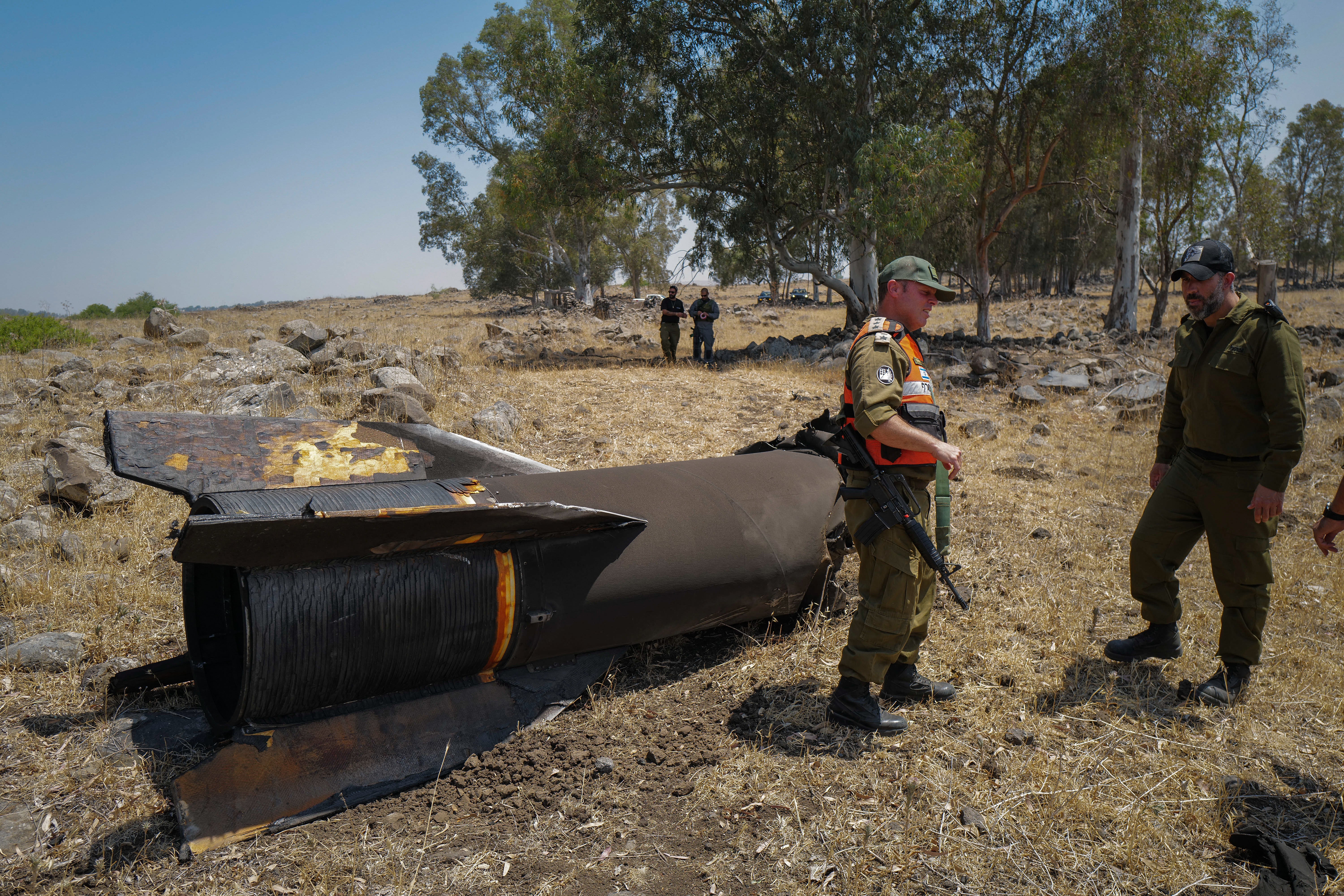 Members of the Israeli security forces check the apparent remains of an Iranian ballistic missile in the Golan Heights in 2025 (AFP/Getty)