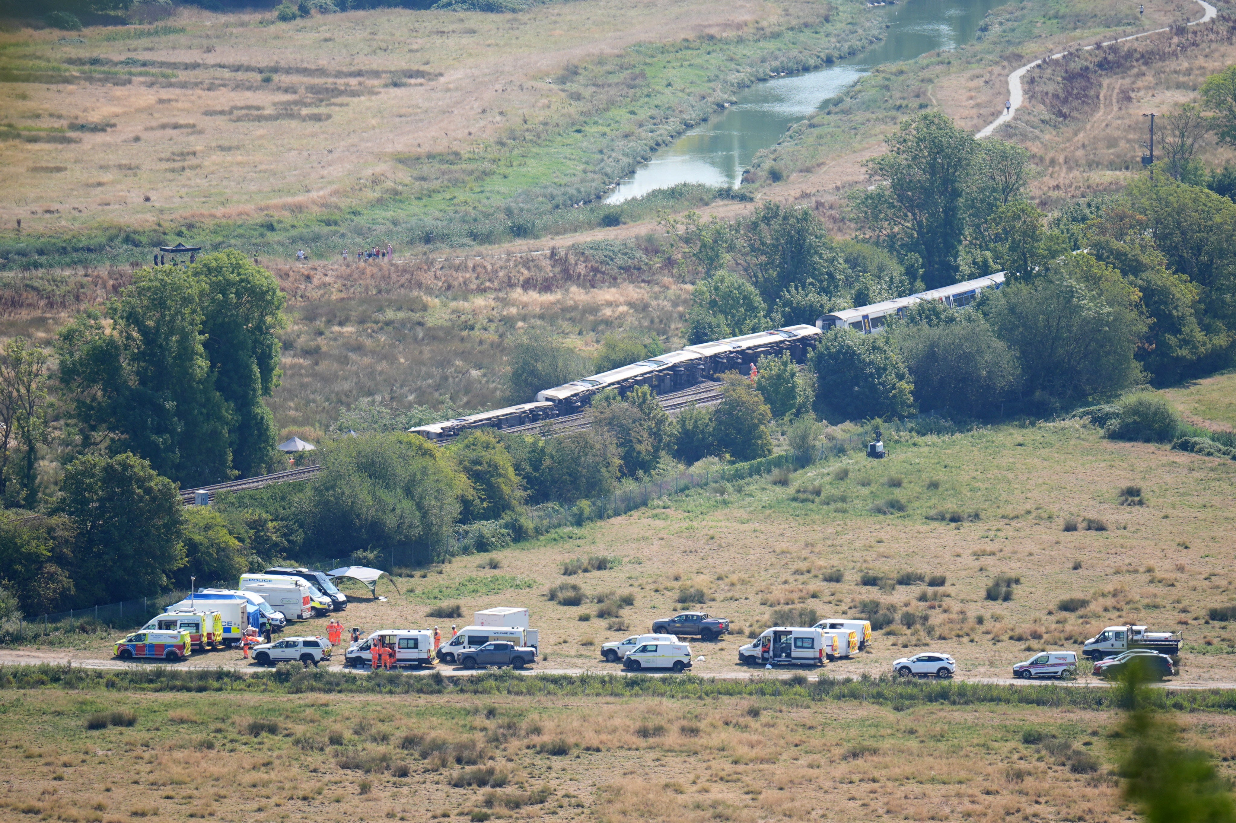 Emergency services at the scene after a train with around 150 people on board derailed (PA)