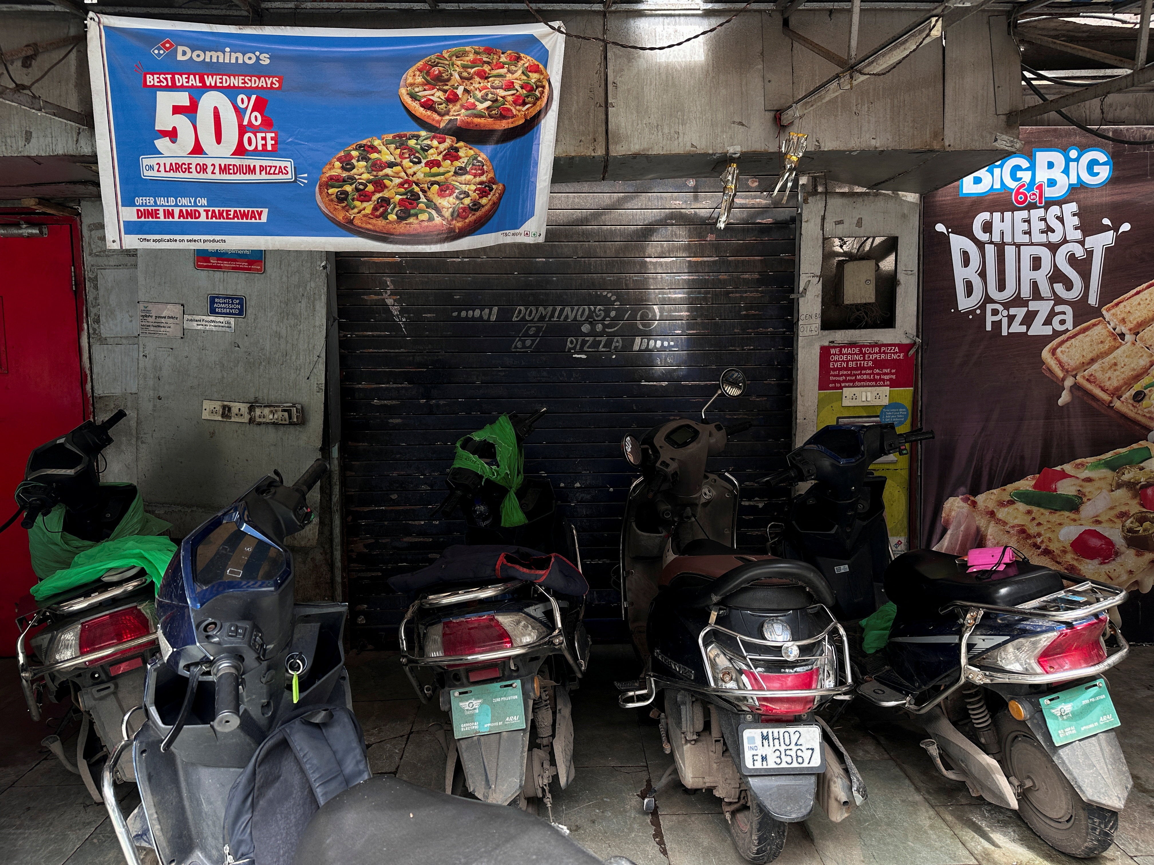Scooters are parked outside a closed Domino's Pizza outlet after Maharashtra's Food and Drug Administration found violations during an inspection in Mumbai, India, August 14, 2026