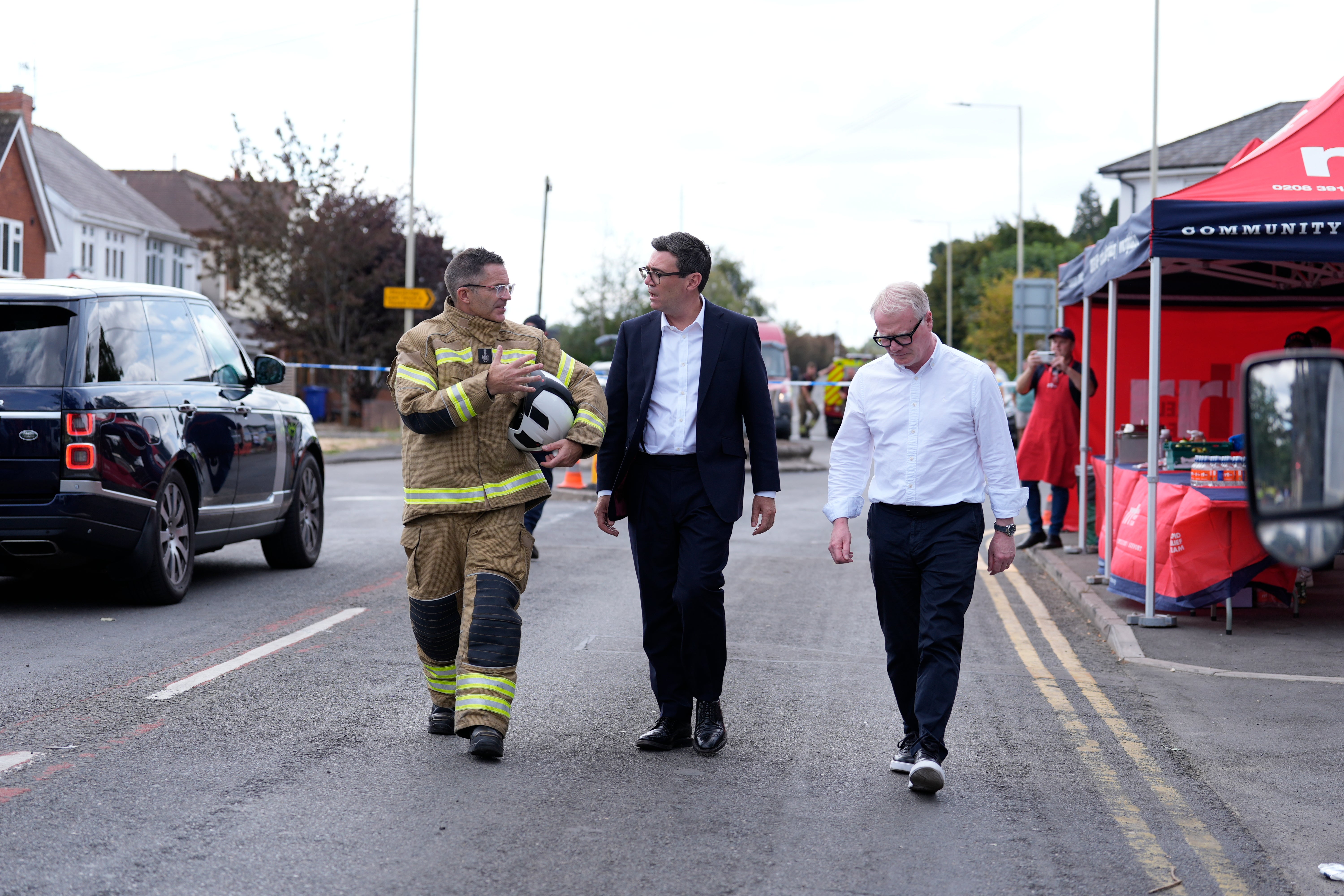 Prime minister Andy Burnham and West Midlands Mayor Richard Parker (right) speaking to West Midlands Fire Service Chief fire officer Simon Tuhill, during a visit to Stourbridge in the West Midlands to discuss the response to wildfires across the region