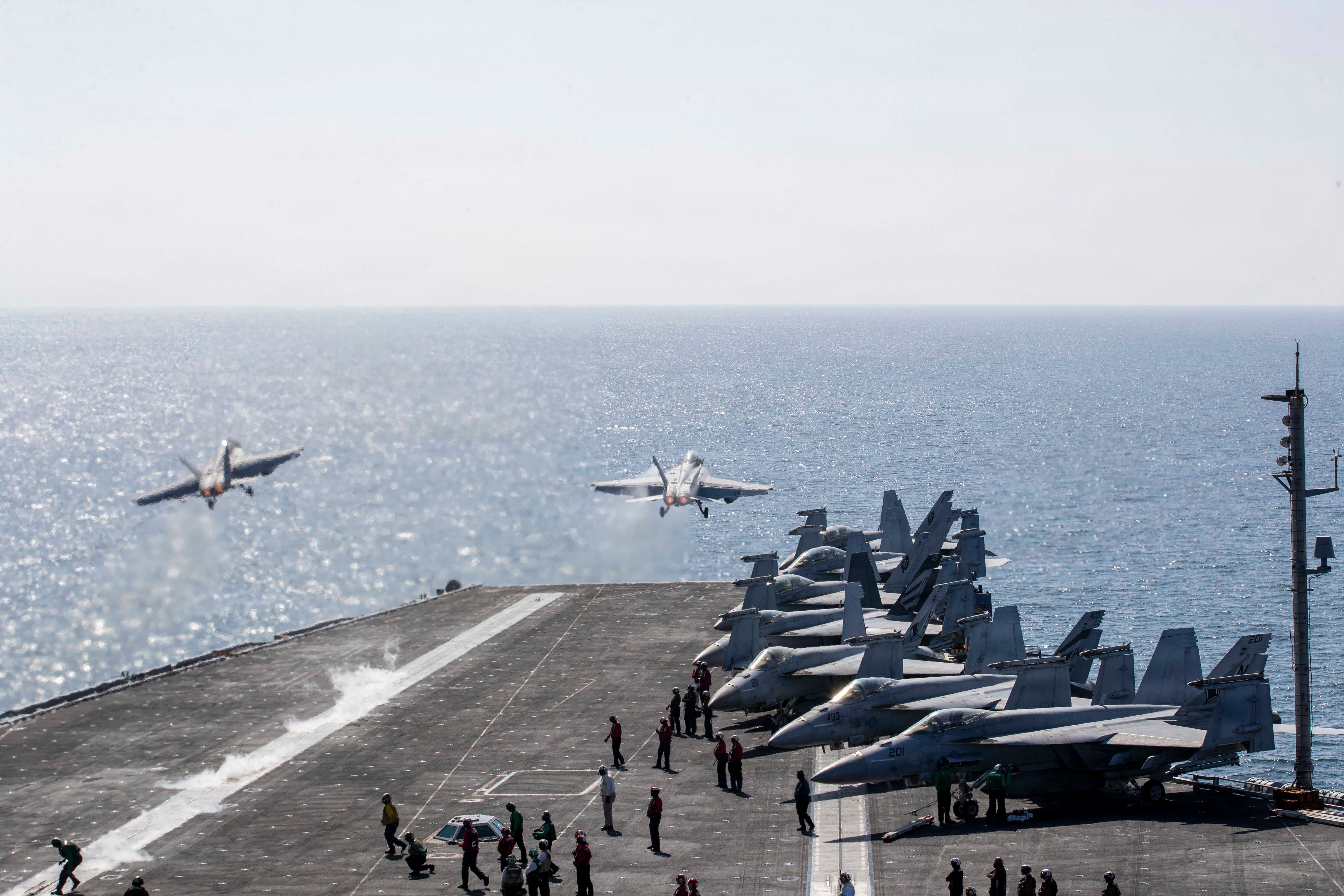 Two F/A-18 Super Hornets launch from the flight deck of the USS Abraham Lincoln in March (Getty)