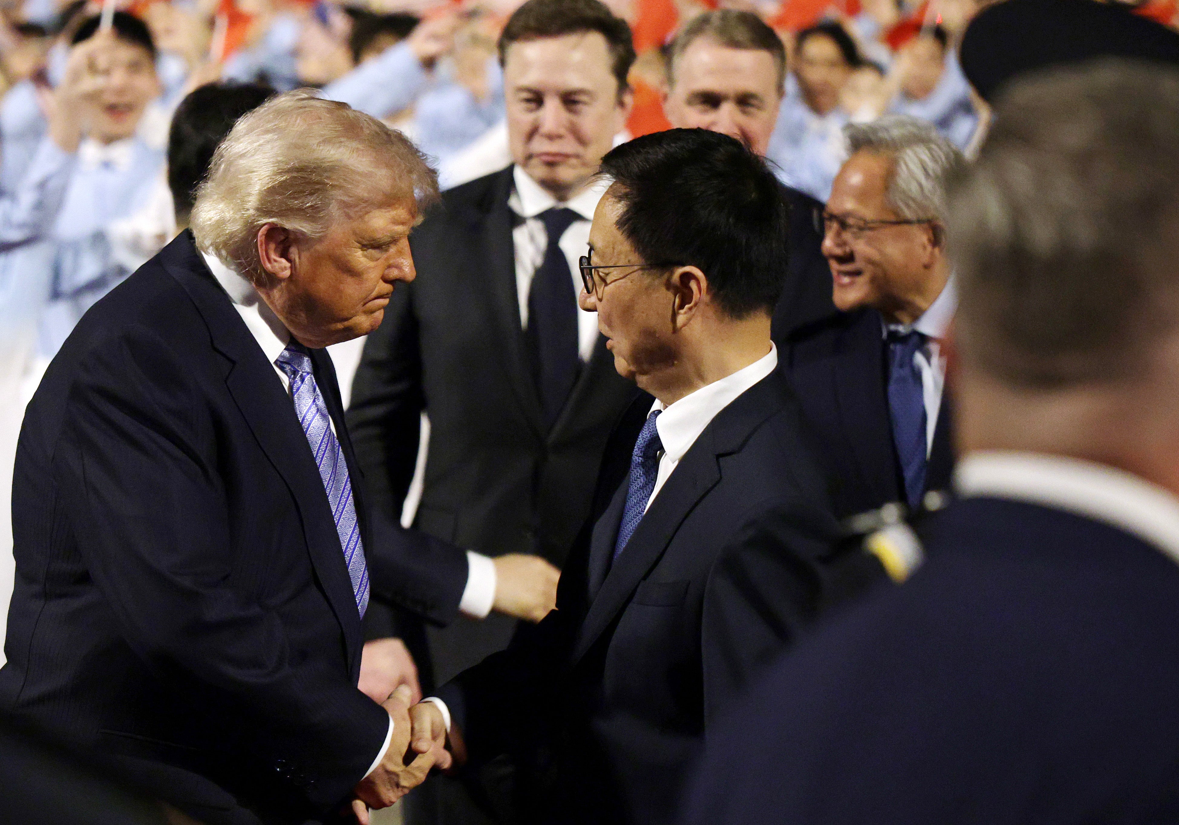 Musk stands nearby as Trump and Chinese Vice President Han Zheng shake hands in Beijing, China, on May 12, 2026