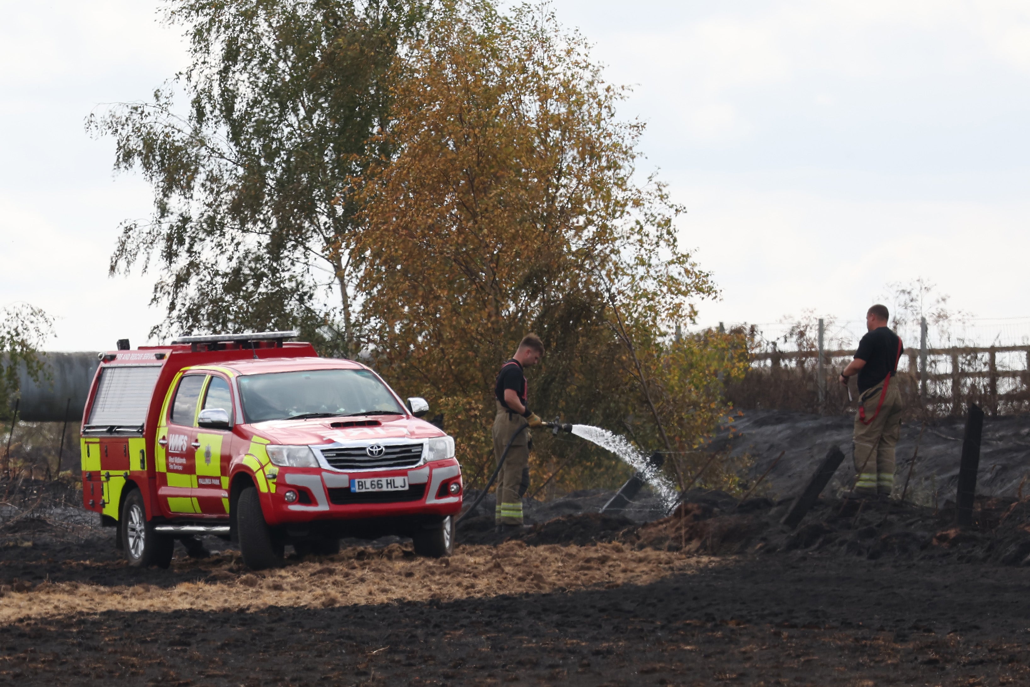 Fire crews continue to work at the scene near the burnt out remains of homes following a huge fire in Stourbridge