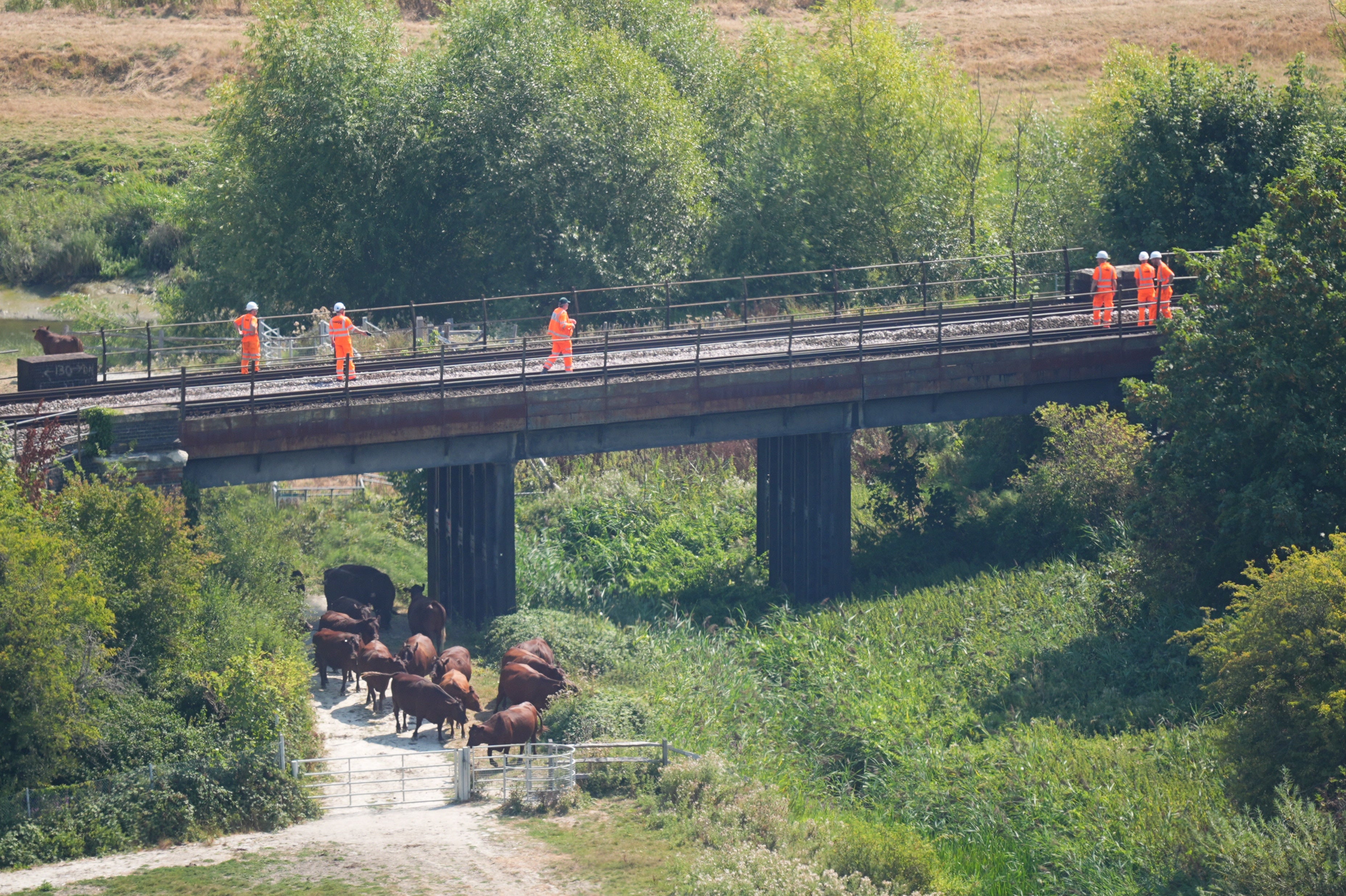 Pictures show rail staff, police and members of the Rail Accident Investigations Bureau (RAIB) beside the tracks on Friday