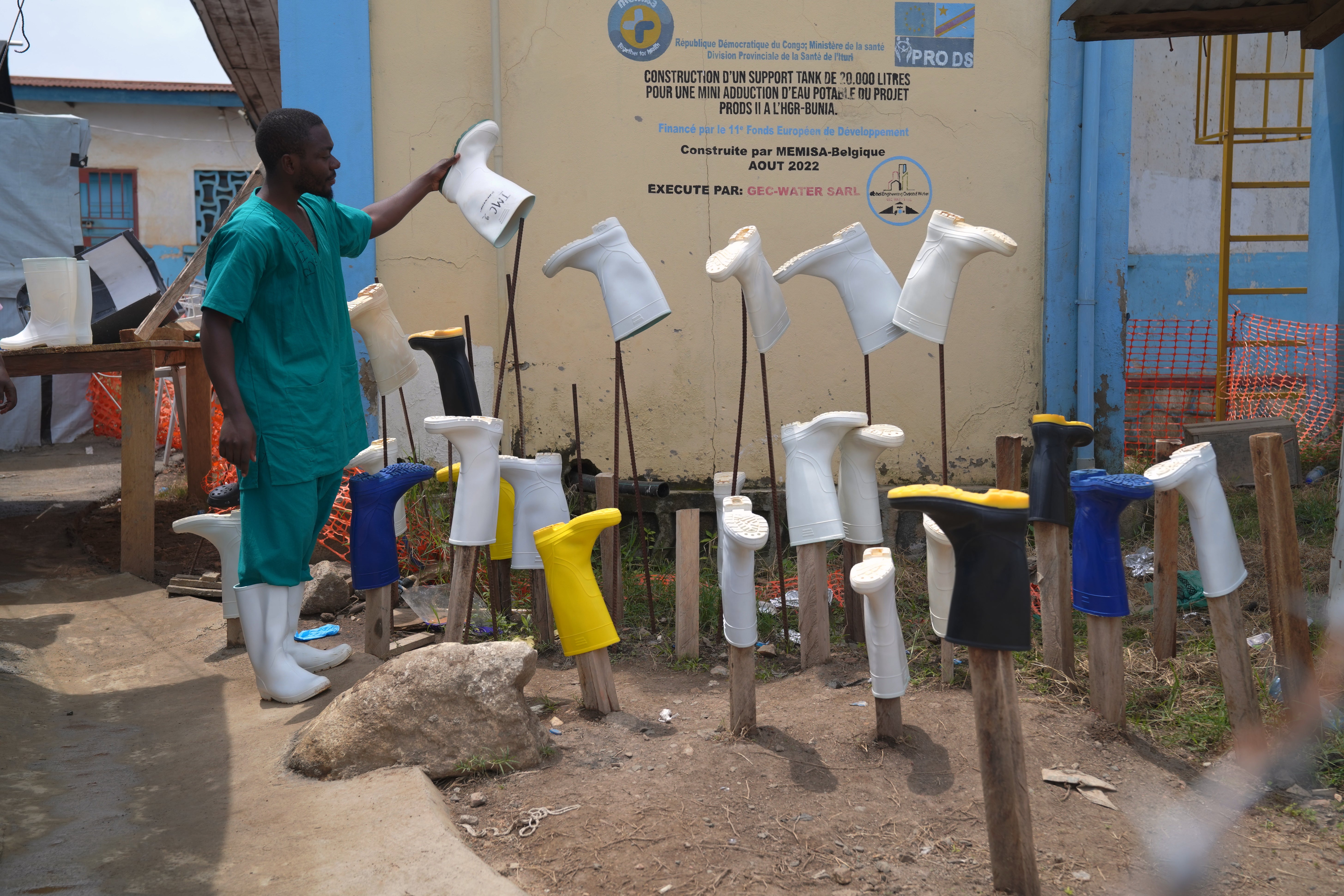 A health worker dries boots that were washed to prevent the spread of Ebola at the treatment centre in eastern Congo