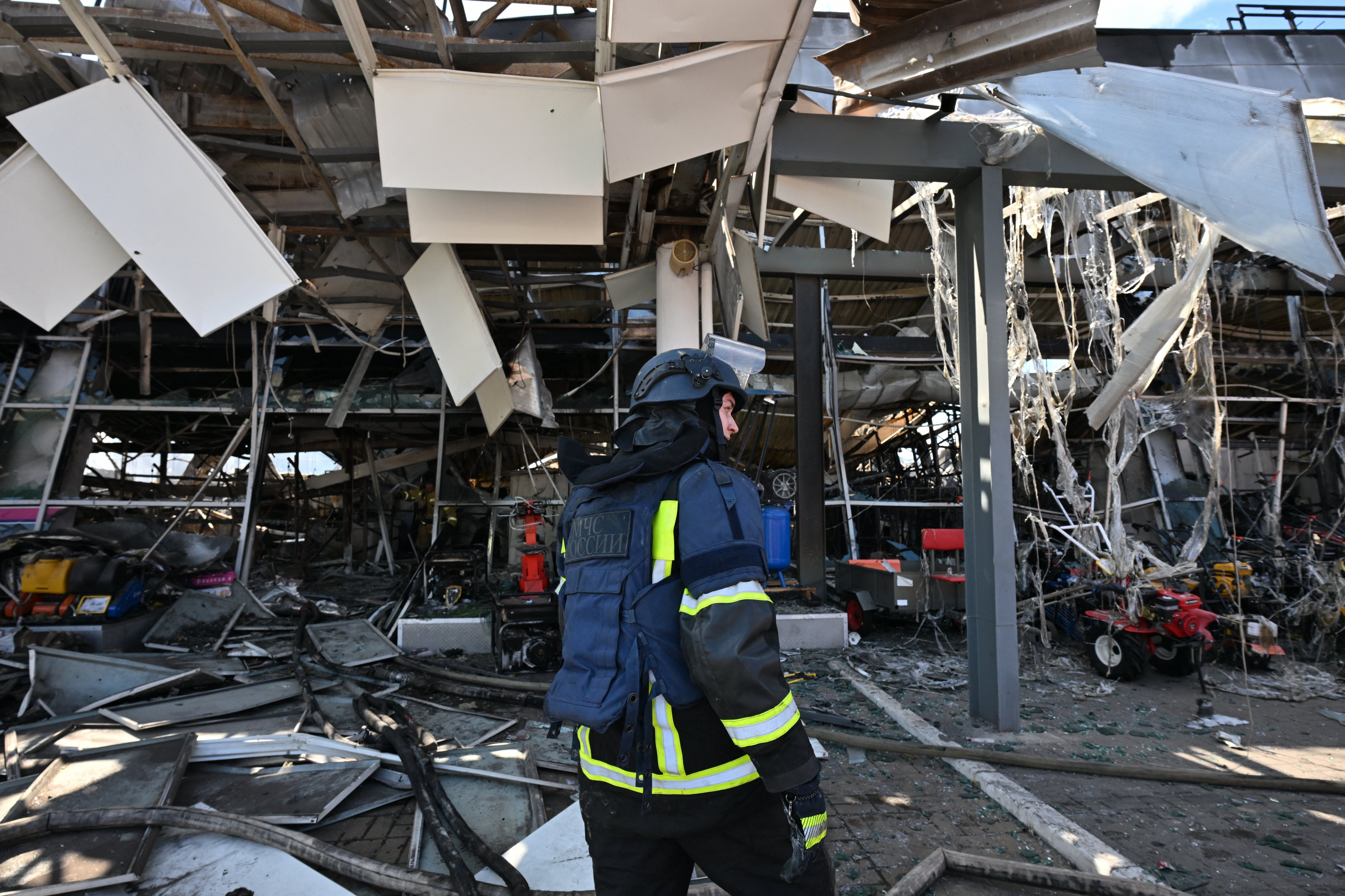 Firefighters work on the grounds of a burned DIY and construction materials mall following an overnight attack, which local Russian-installed officials called Ukrainian drone strikes, in Yenakiyeve in the Donetsk region, Russian-controlled Ukraine, on August 14, 2026, amid the ongoing Russian-Ukrainian conflict (AFP/Getty)