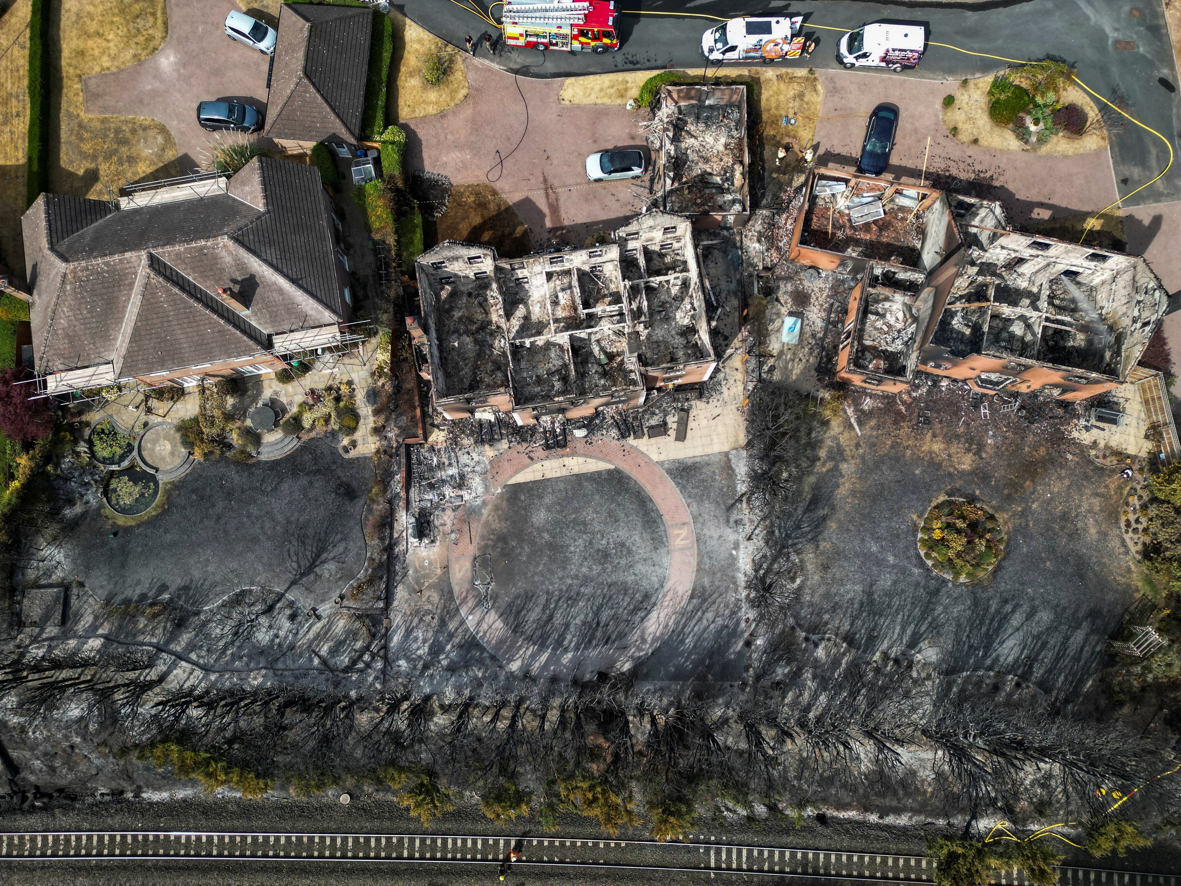 A drone view of burnt-out houses following a large grass fire which spread to several homes yesterday during the hottest day of the year, in Stourbridge