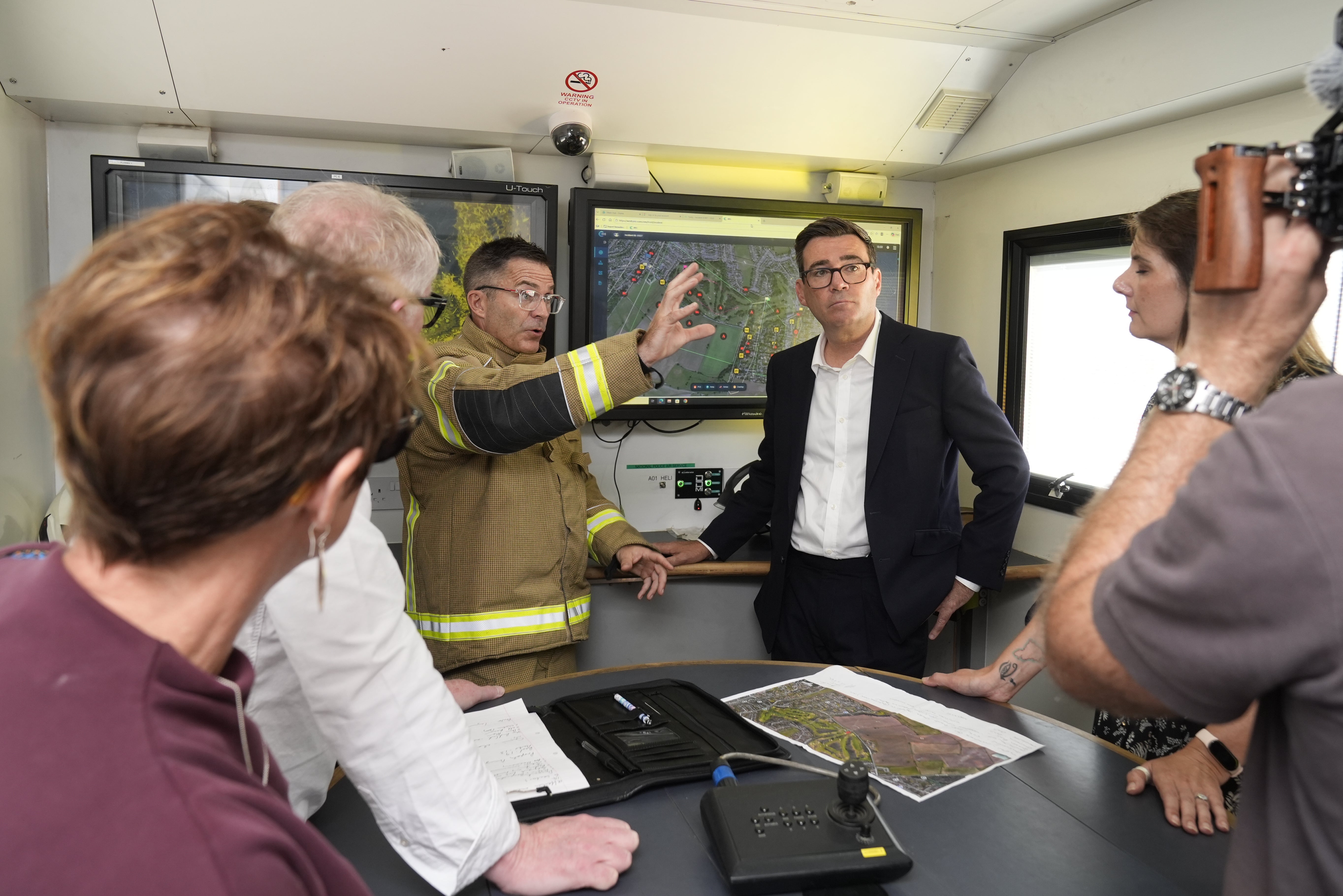 Prime Minister Andy Burnham speak to emergency responders at the West Midlands Fire Service incident command unit during a visit to Stourbridge in the West Midlands (Getty)