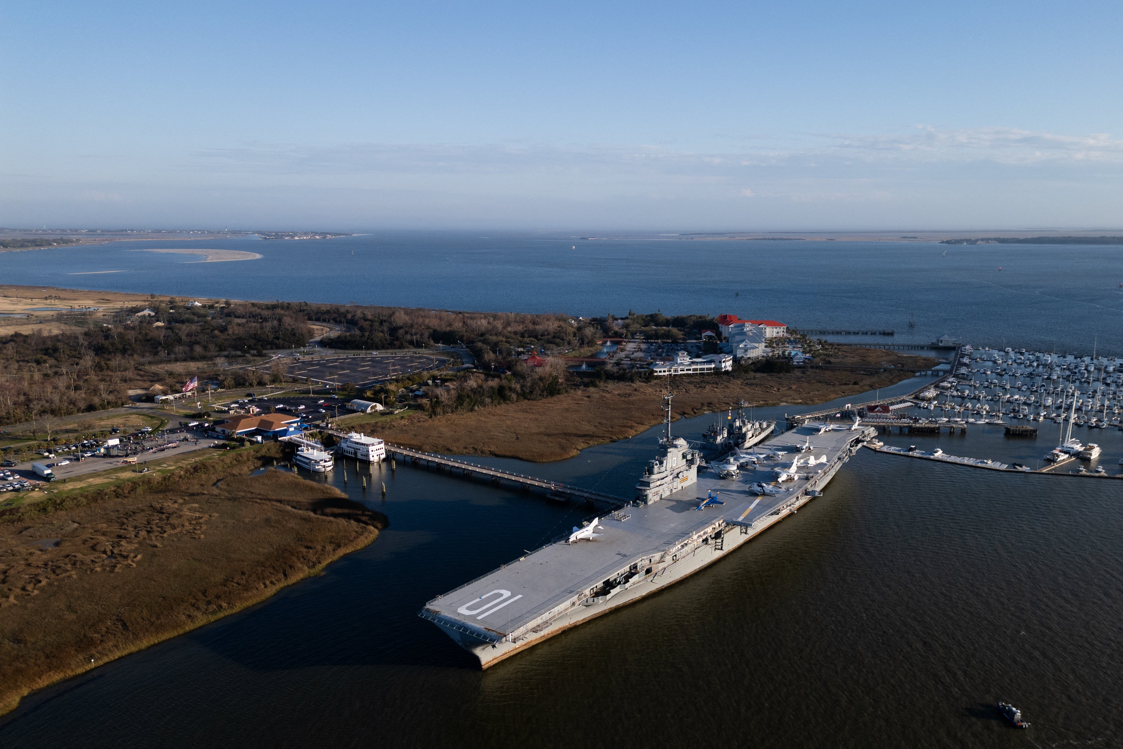 In WW2 era ships, such as the pictured USS Yorktown, the tower was more in the middle