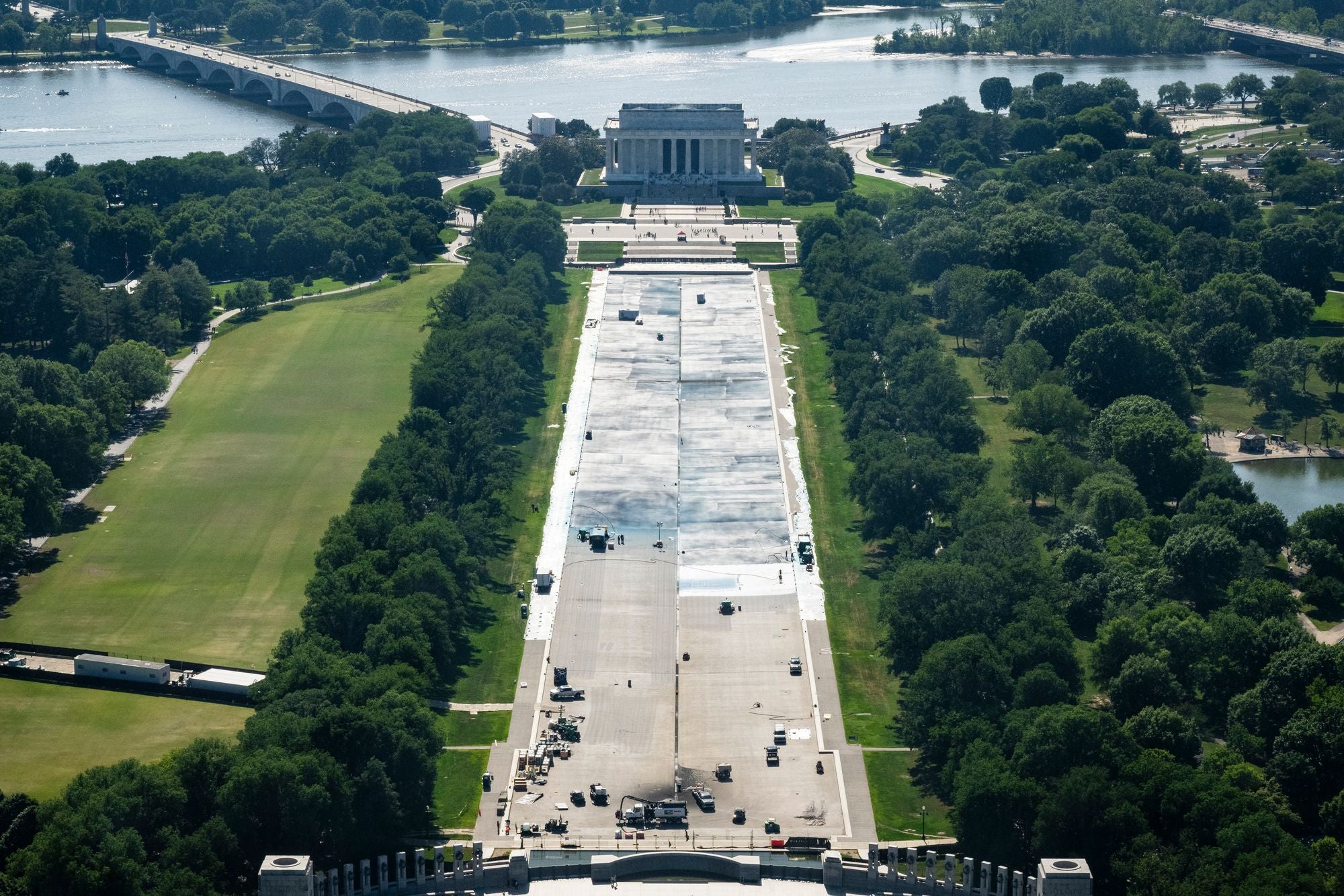 Workers paint the bottom of the Lincoln Memorial Reflecting Pool on the National Mall as seen from the Washington Monument on May 17, 2026 in Washington, DC
