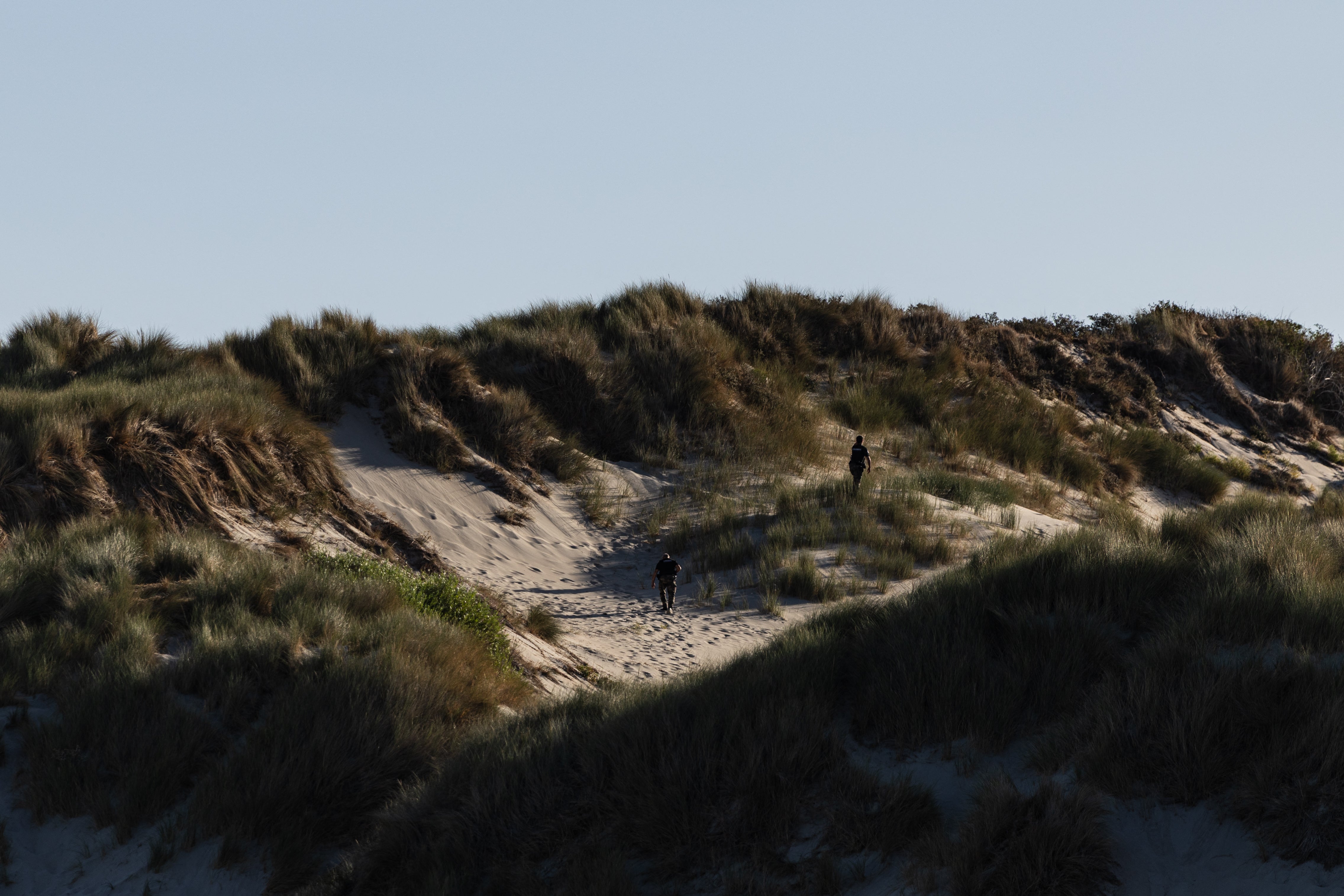 French Gendarmes patrol the dunes to prevent migrants from crossing the English Channel in Fort-Mahon-Plage, northern France, on August 13, 2026.