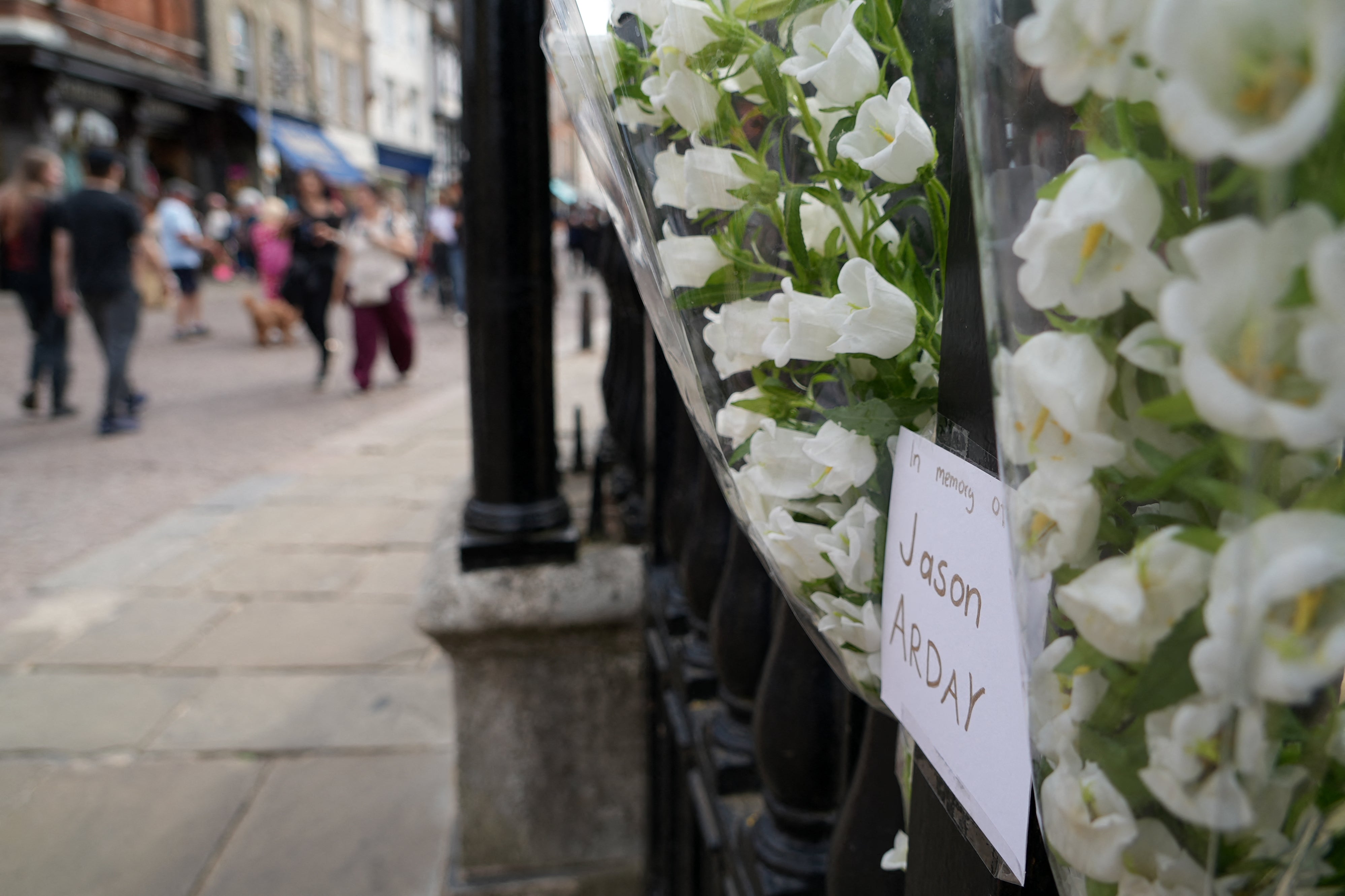Floral tributes to remember academic Jason Arday attached to the railings outside Senate House in the University of Cambridge on August 15, 2026