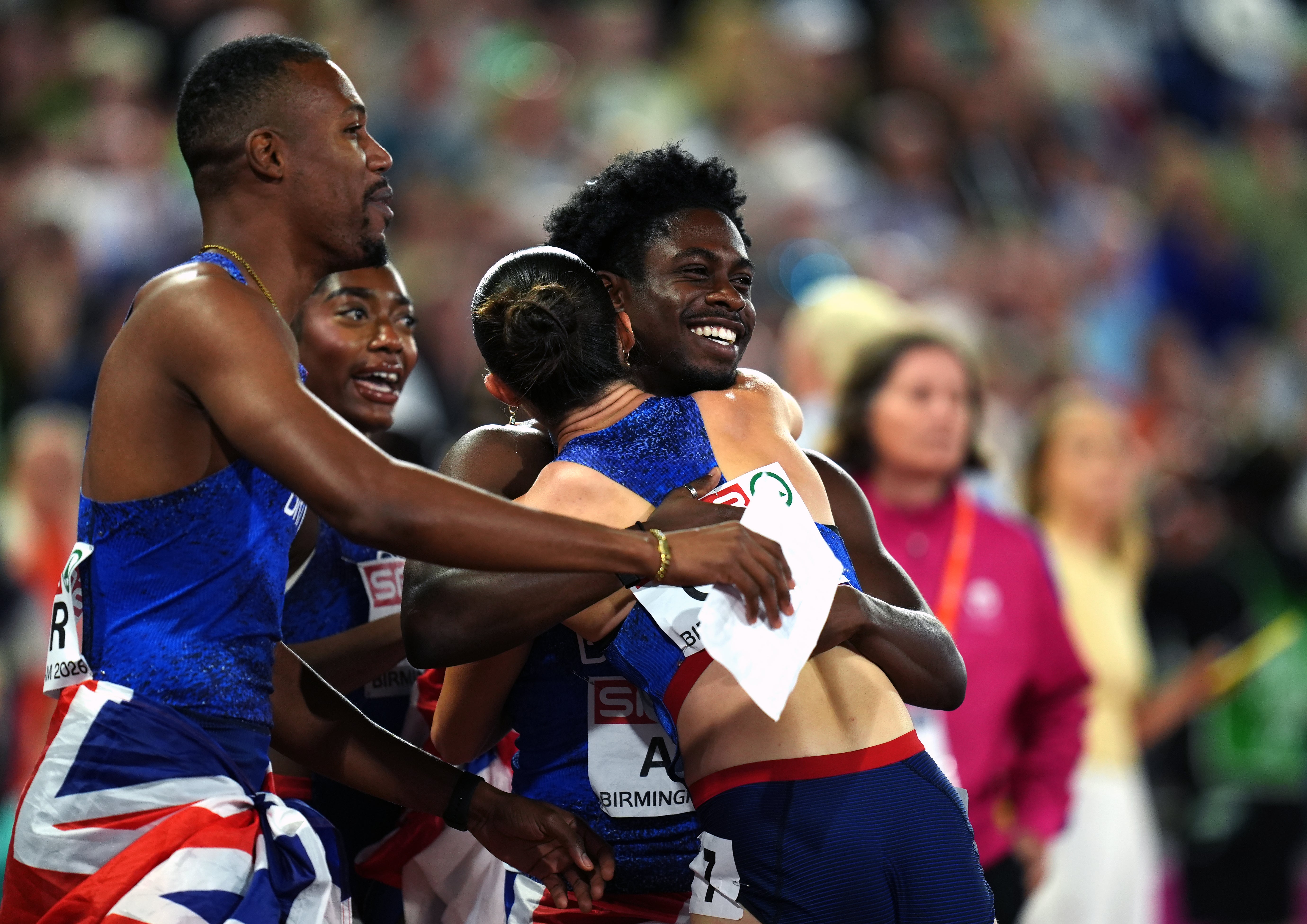 Jeremiah Azu, right, hugs Amy Hunt as they celebrate their relay gold medals (Annabel Lee-Ellis/PA)