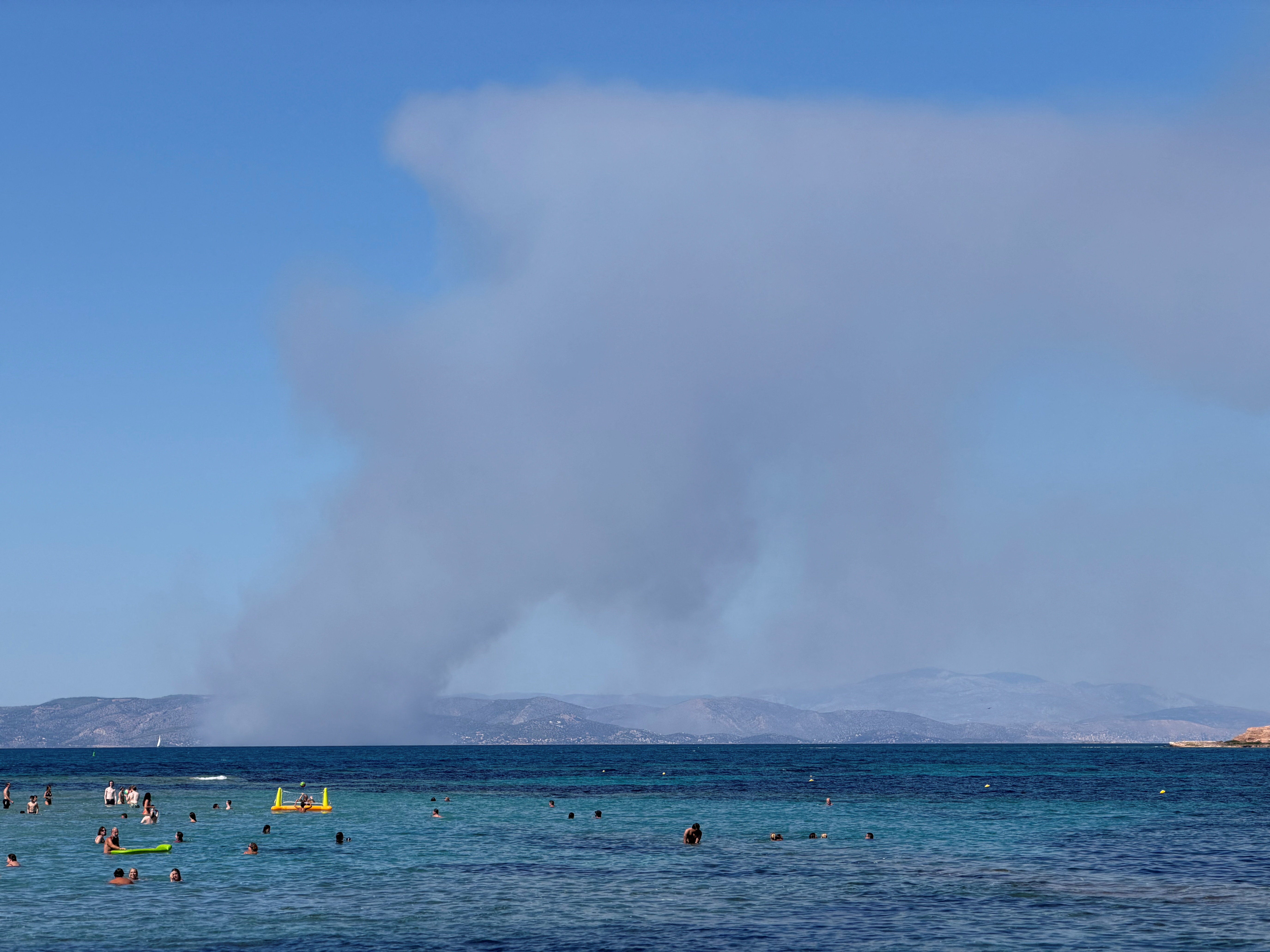Two dead as fast-moving wildfires sweep Greek island of Salamina with residents preparing to evacuate