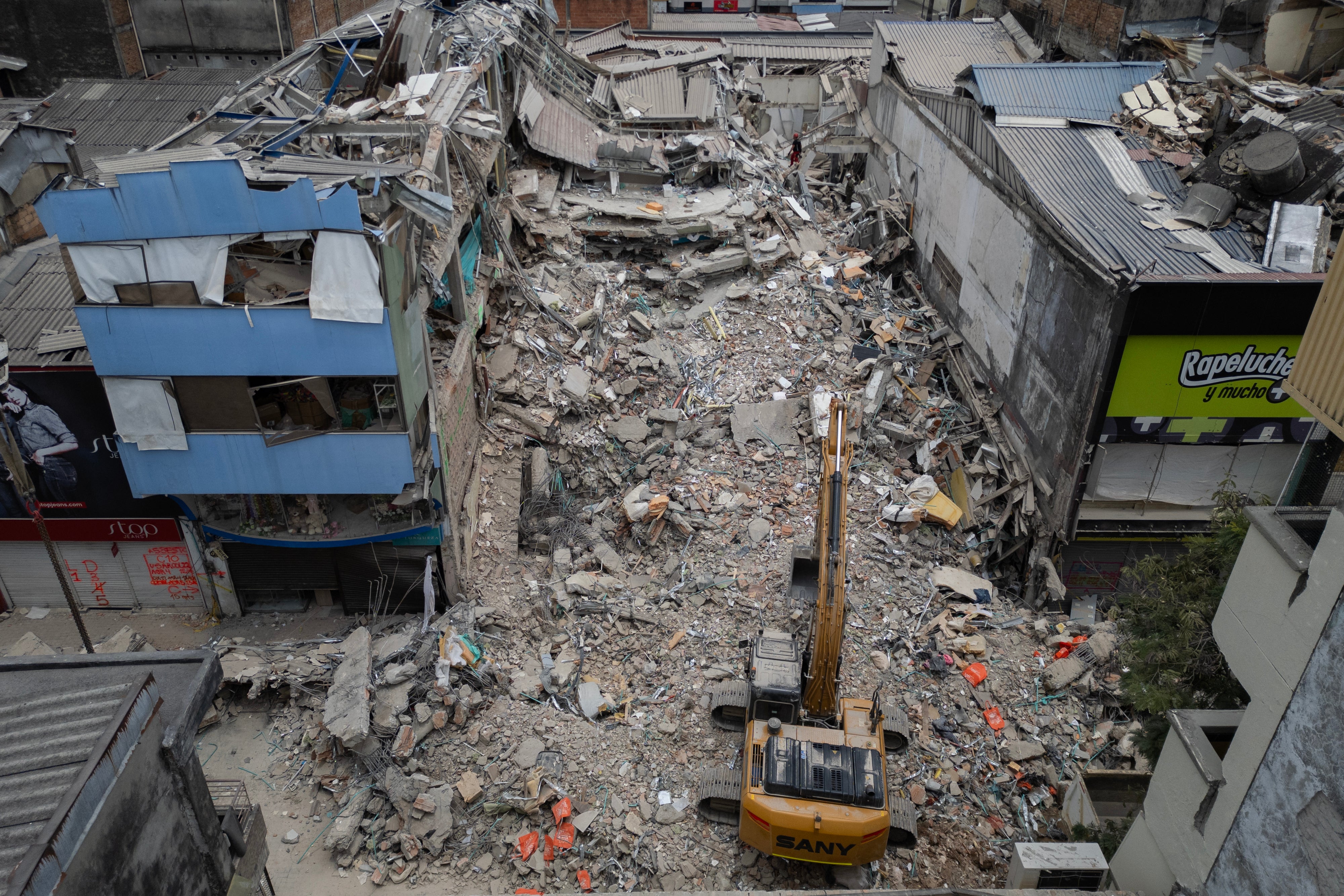 A backhoe removes debris from collapsed buildings in Pereira, Colombia, on August 15, 2026