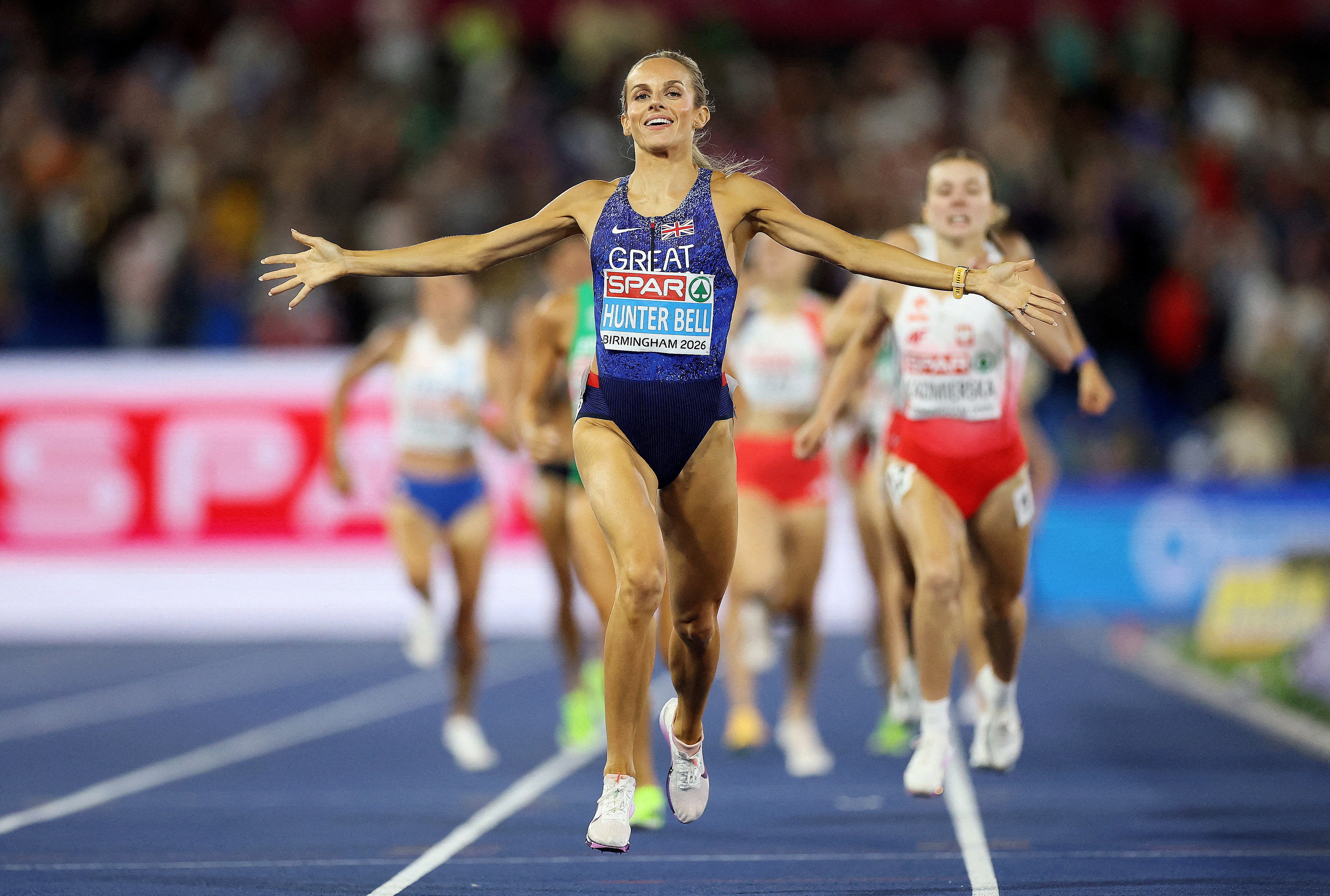 Georgia Hunter Bell celebrates as she crosses the finish line