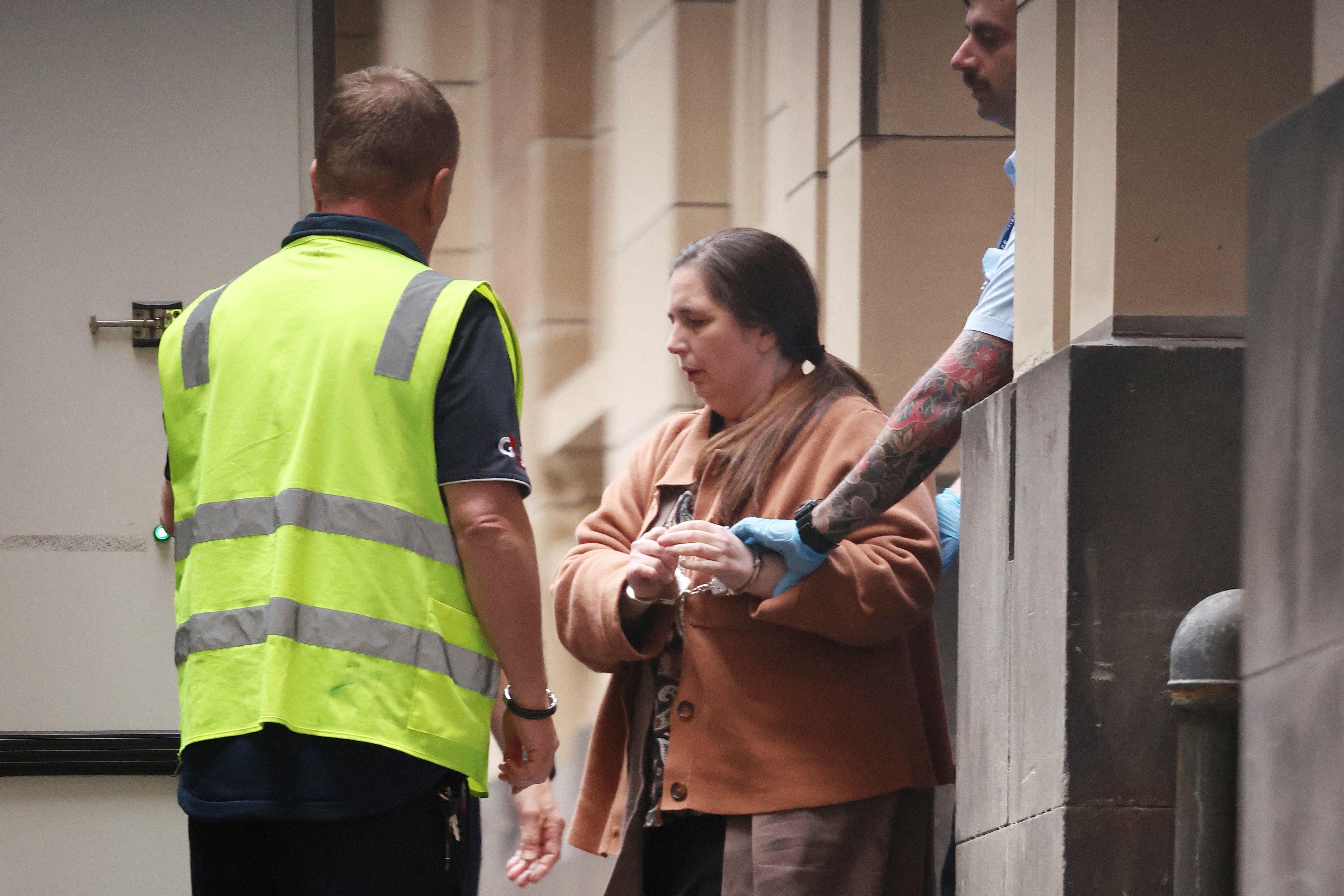 Convicted murderer Erin Patterson is escorted out of the Supreme Court of Victoria following the day's proceedings in a pre-sentencing hearing in Melbourne on 25 August 2025