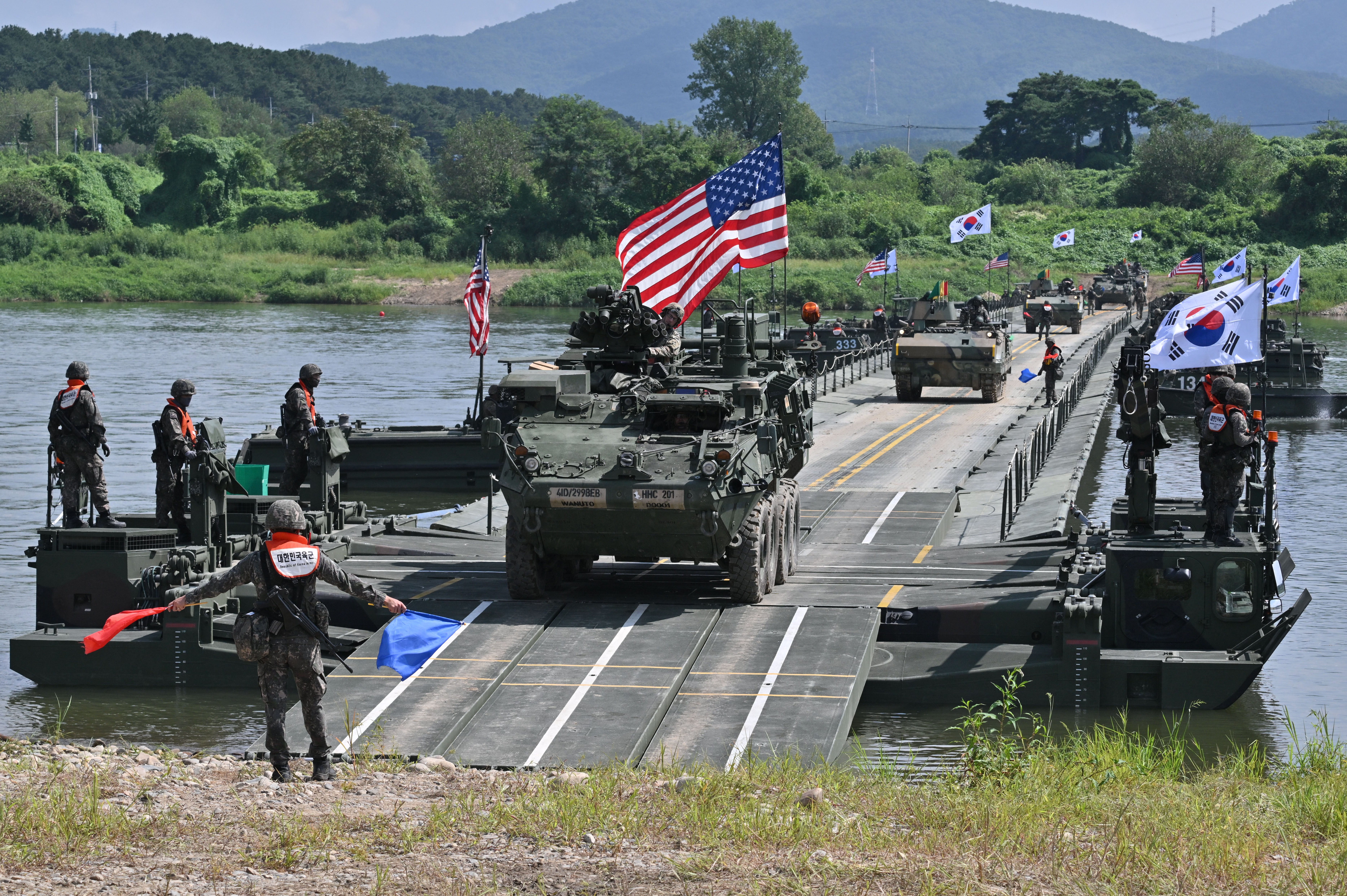 A US Stryker infantry carrier vehicle (C) crosses a river over a floating bridge during a South Korea-US joint river-crossing drill as part of the annual Ulchi Freedom Shield military exercise in 2025 (AFP/Getty)