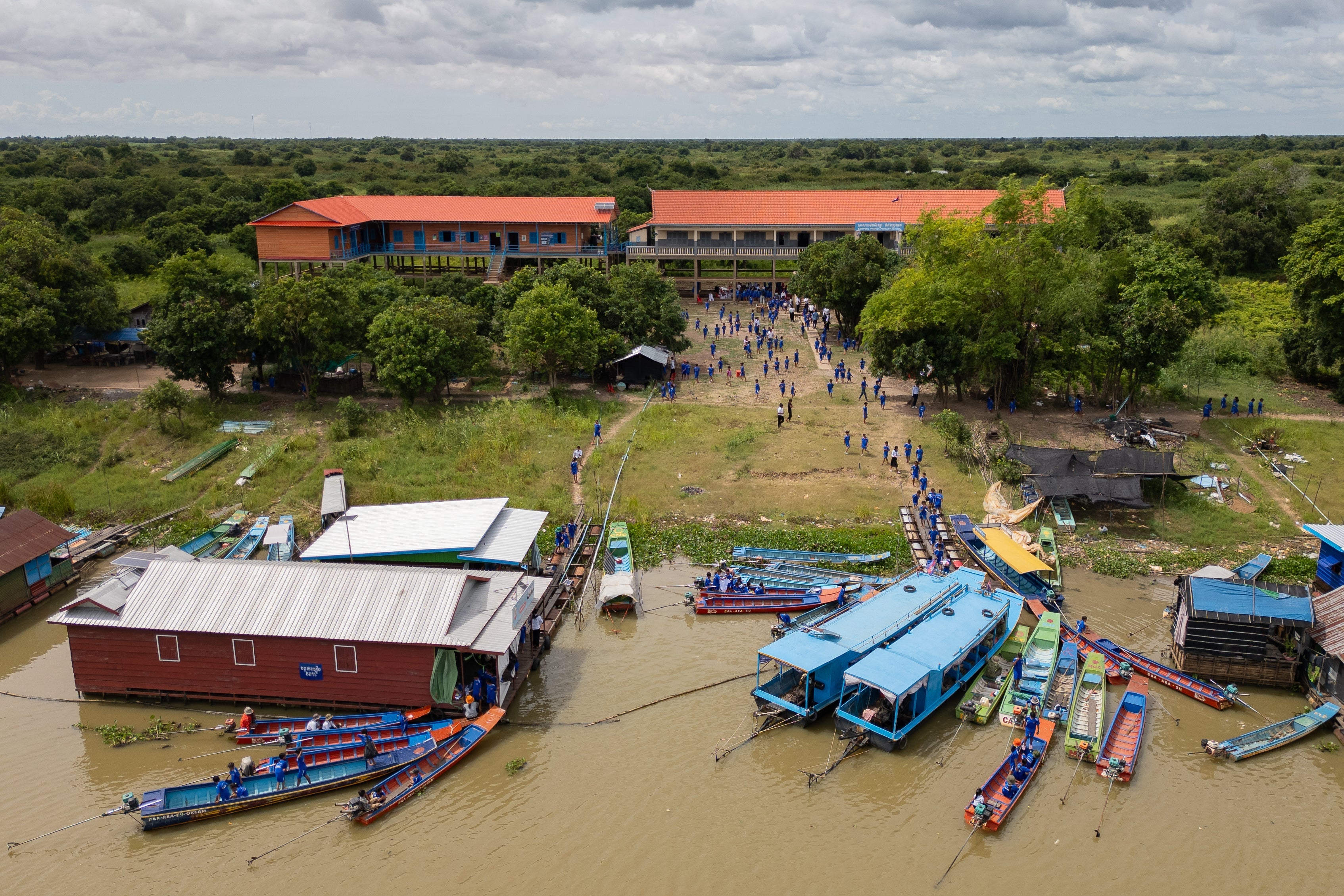 Students arrive at a school in a floating village on the Tonle Sap Lake, Cambodia