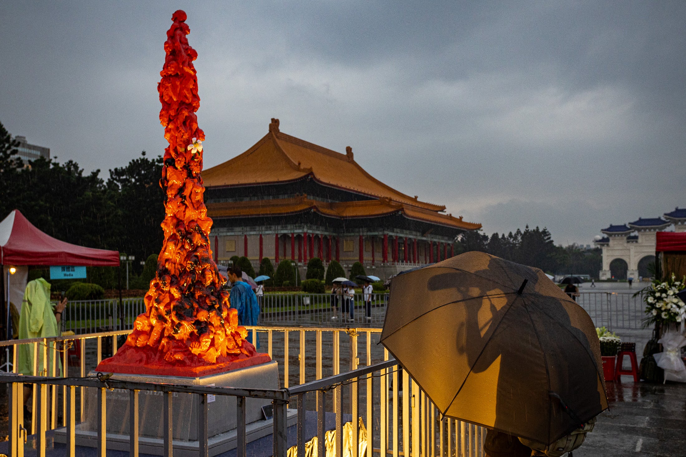 People gather during a vigil near the illuminated "Pillar of Shame" monument at Liberty Square in Taipei on June 4, 2026 to commemorate the anniversary of China's 1989 crackdown on pro-democracy protesters in Beijing's Tiananmen Square