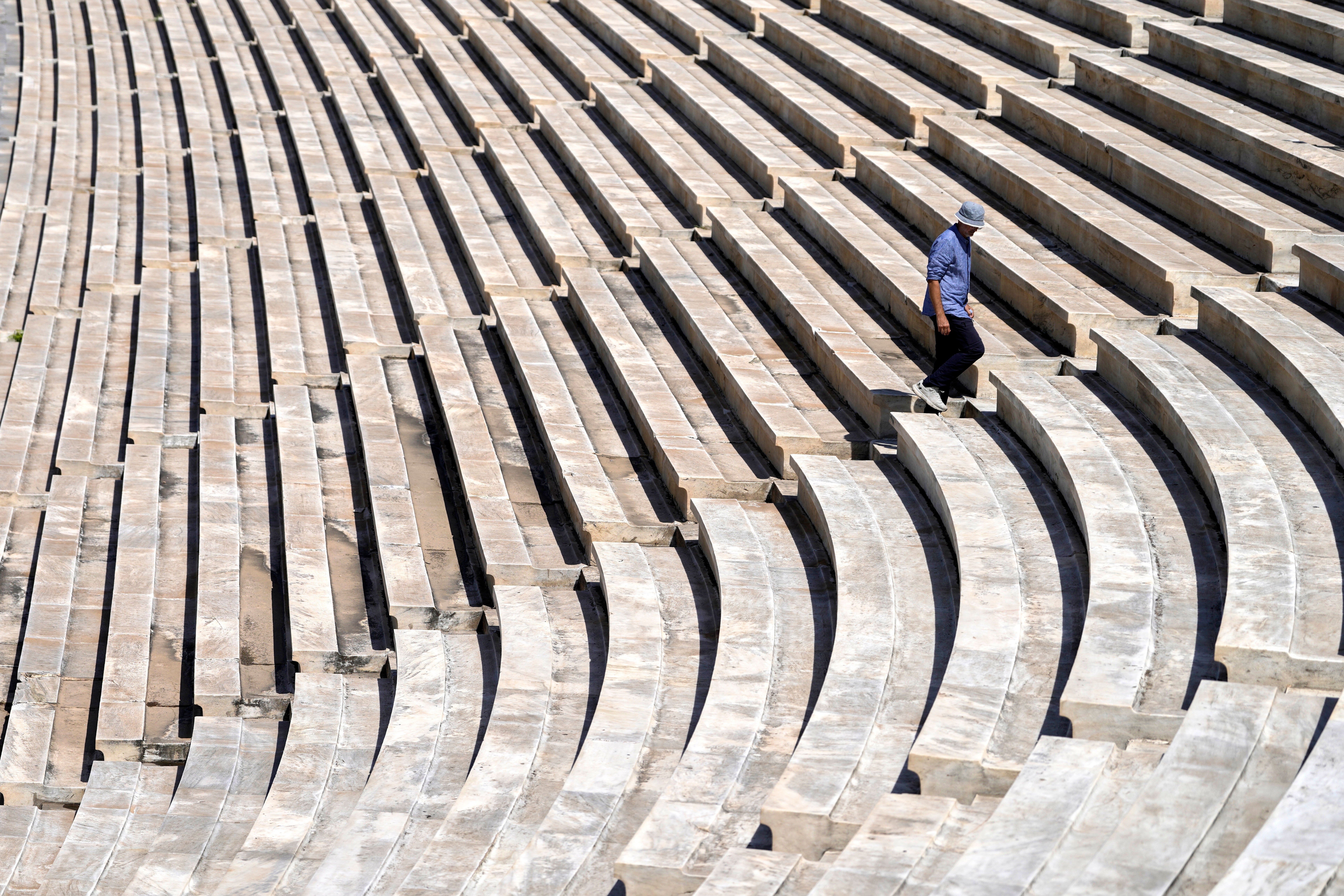 Dimitris Selimis, a senior conservator at the site, inspects the cleaned marble surfaces of the Panathenaic Stadium