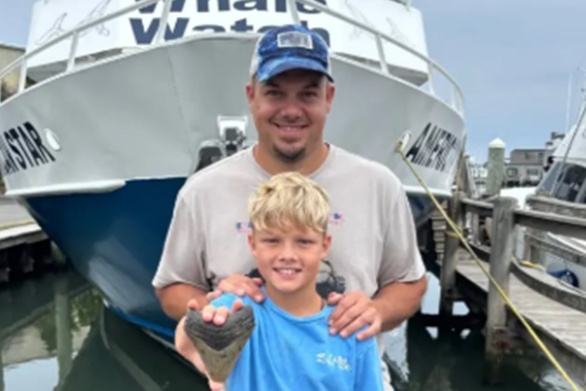 Michael Bowers and his 11-year-old son Bo with a megalodon shark tooth they discovered in Cape May, New Jersey