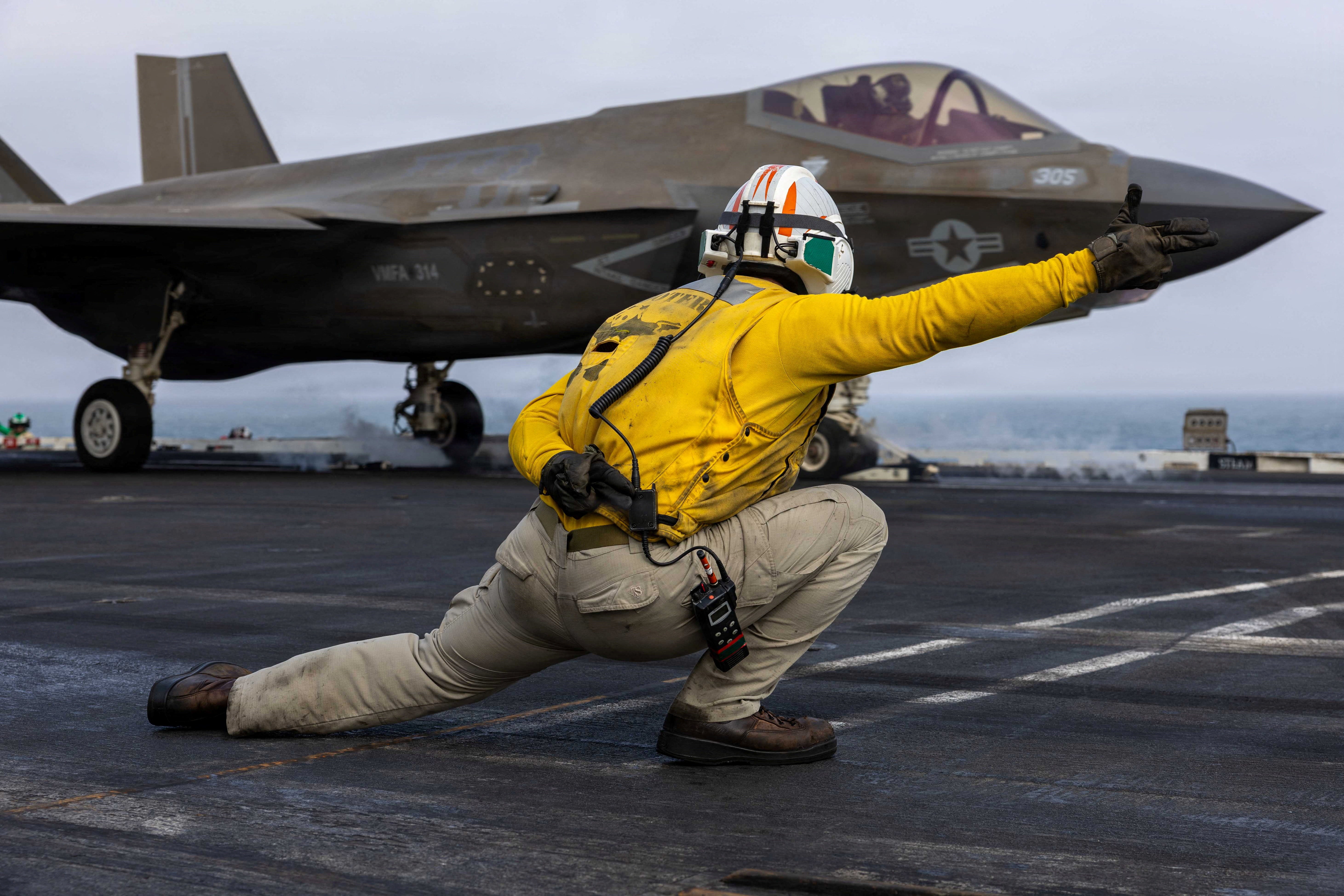 A U.S. sailor launches an F-35C Lightning II, assigned to Marine Fighter Attack Squadron 314, from the flight deck of Nimitz-class aircraft carrier USS Abraham Lincoln during the ongoing conflict with Iran August 5, 2026