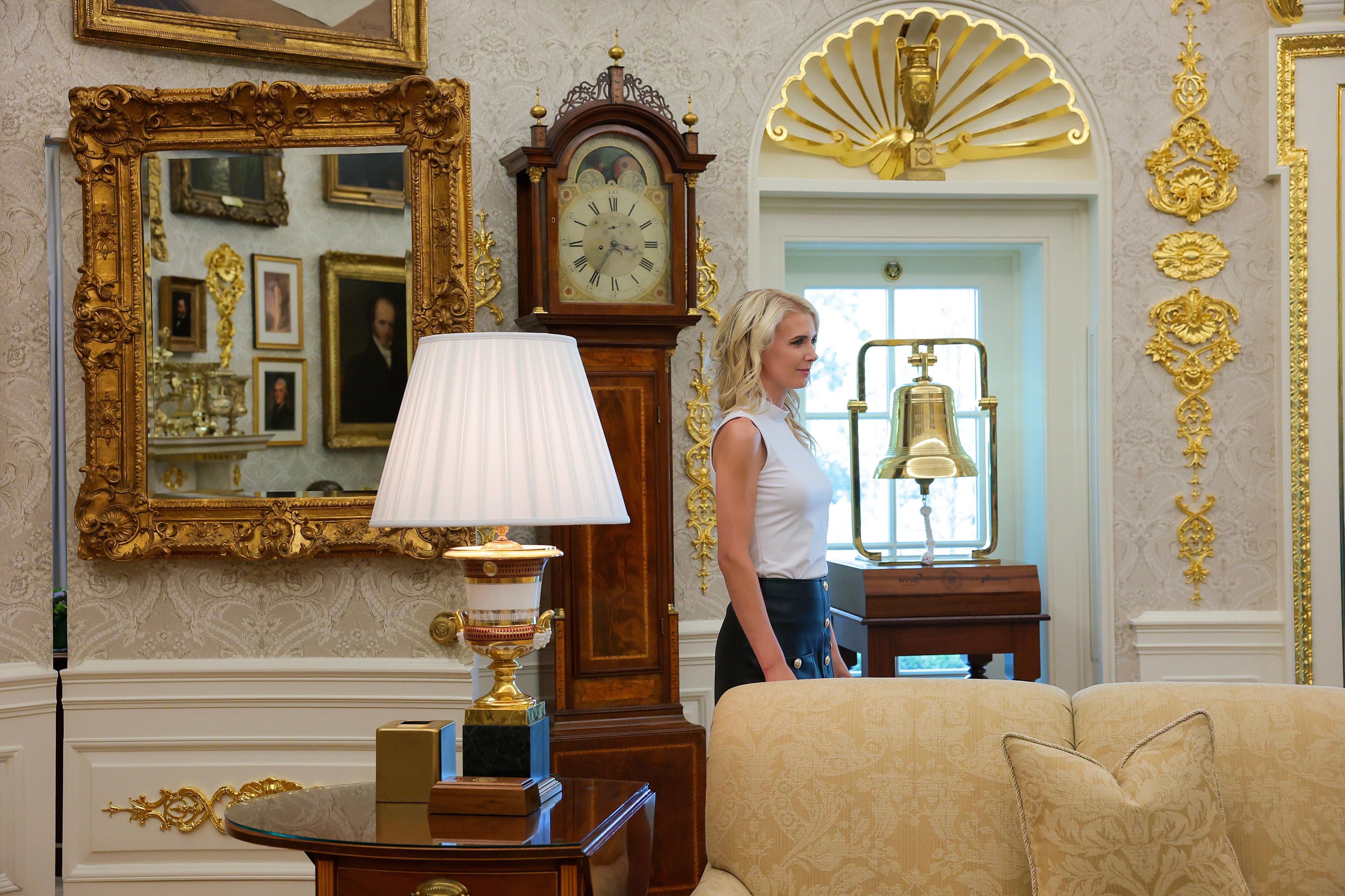 Executive Assistant to the President Natalie Harp stands in the Oval Office Trump signs an executive order calling for childhood vaccine shots to be spaced out into separate visits on August 10