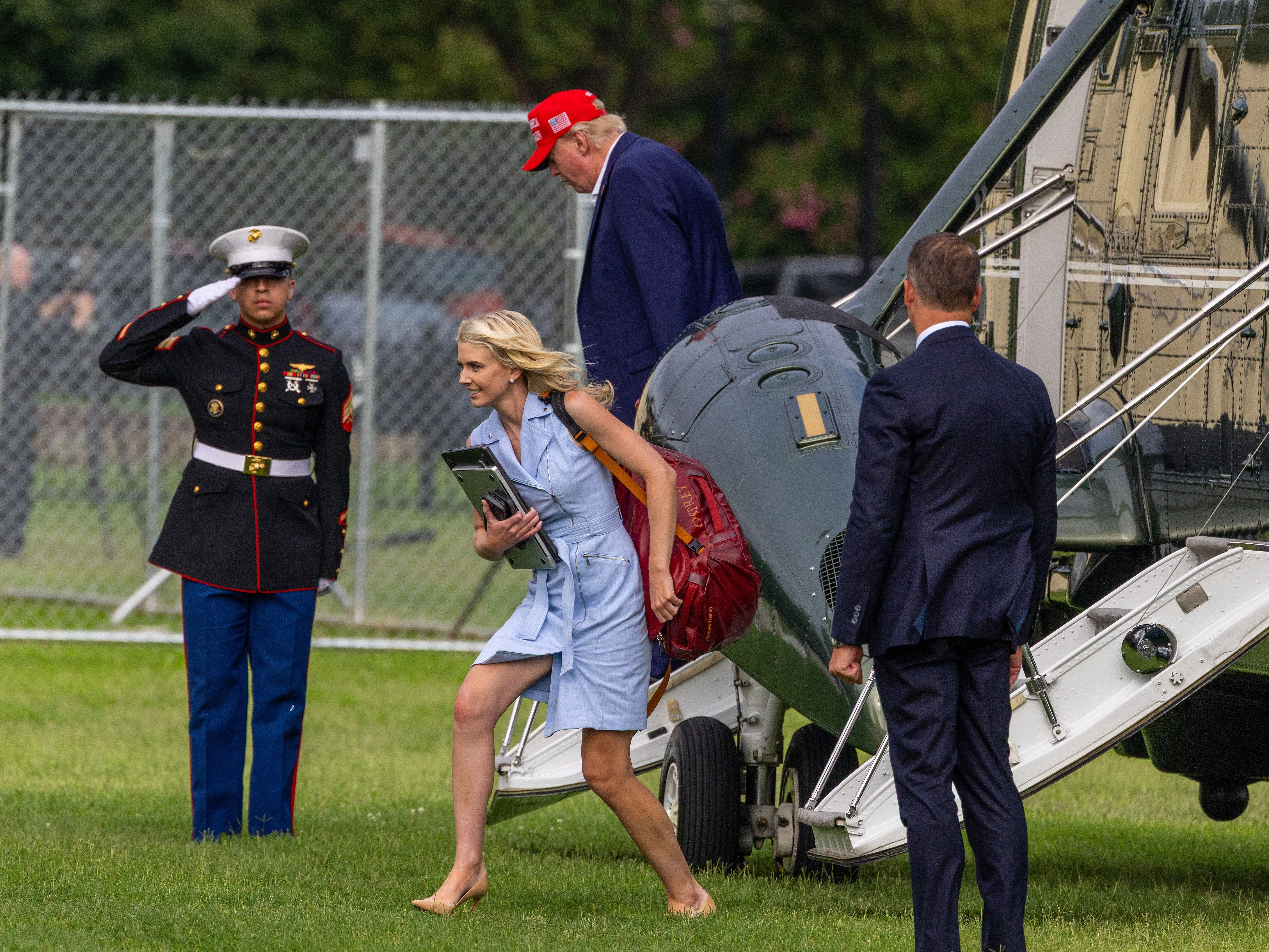 U.S. President Donald Trump steps off Marine One along with Natalie Harp, aide to U.S. President Donald Trump after landing at the Ellipse near the White House on August 16, 2026 in Washington, DC. (Getty)